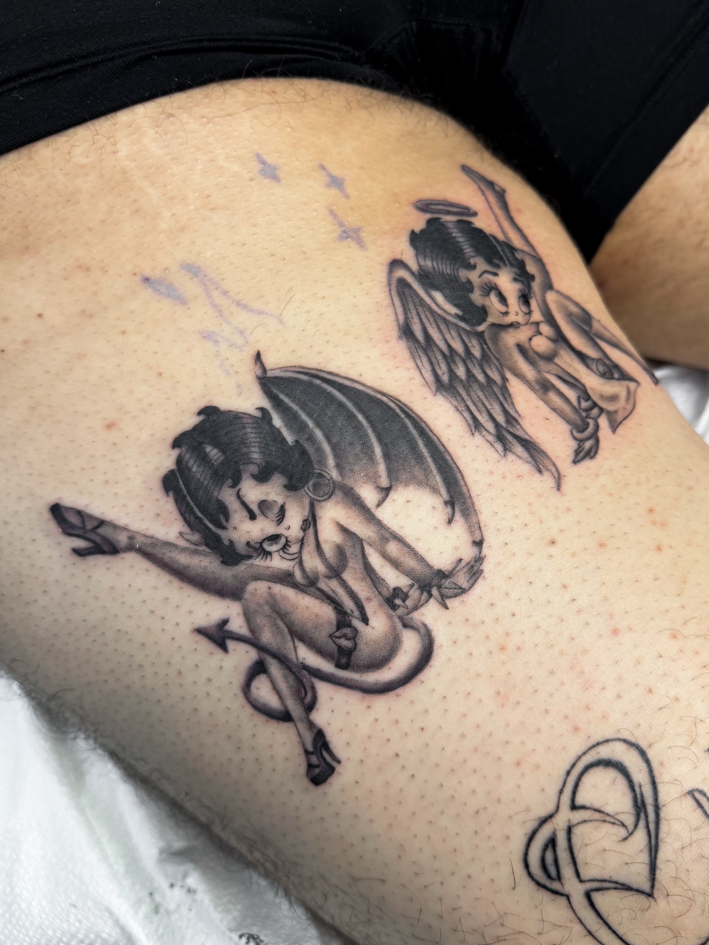 Cherub black and grey tattoo on the thigh by @nudylicioustattoos