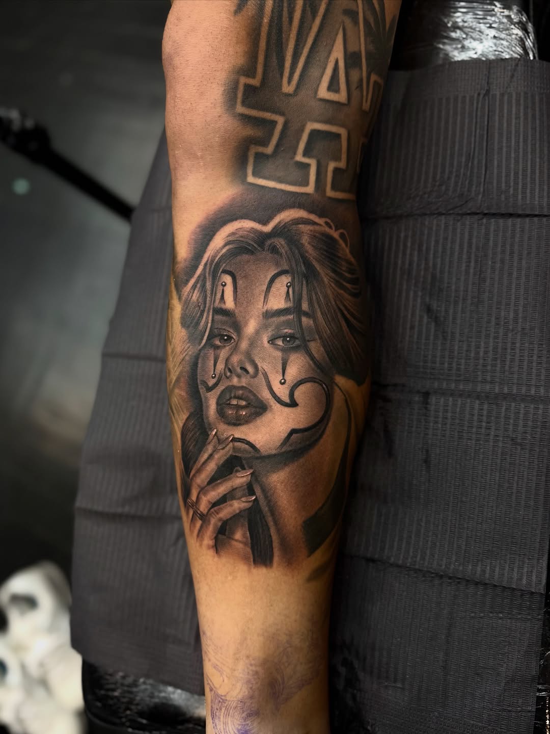 Chola clown girl portrait Chicano tattoo on the forearm by Luis Peña
