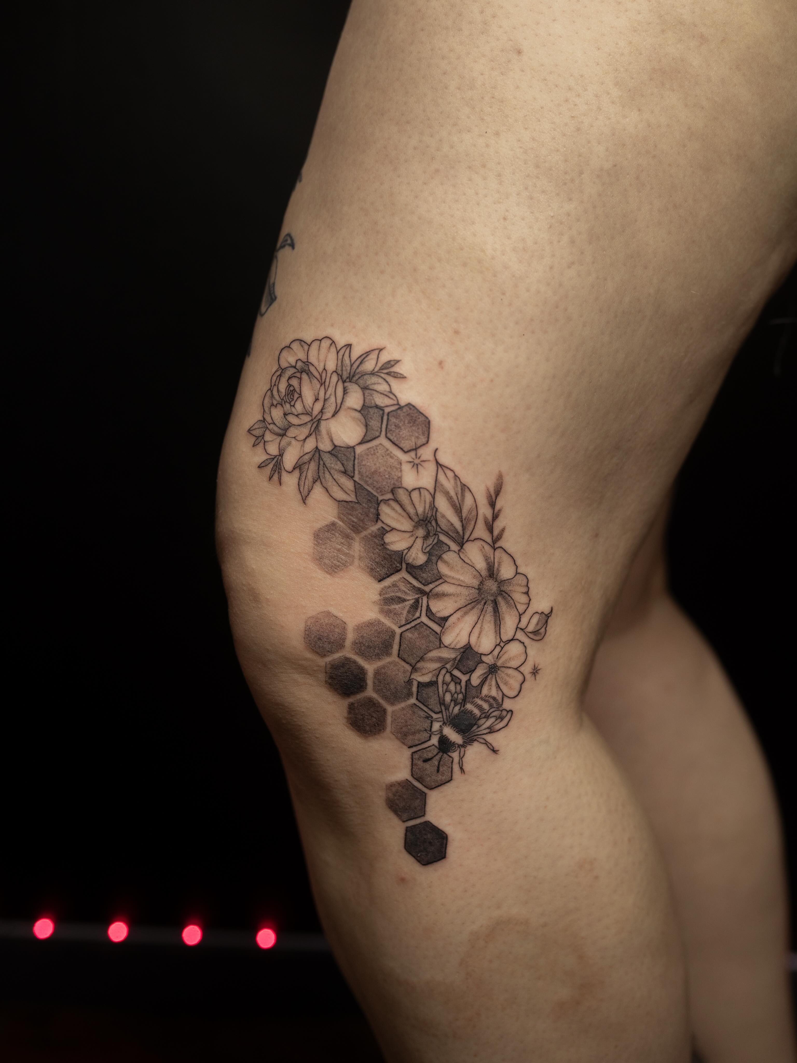 Hexagon pattern with flowers and bee geometric tattoo on the thigh by Kelsie
