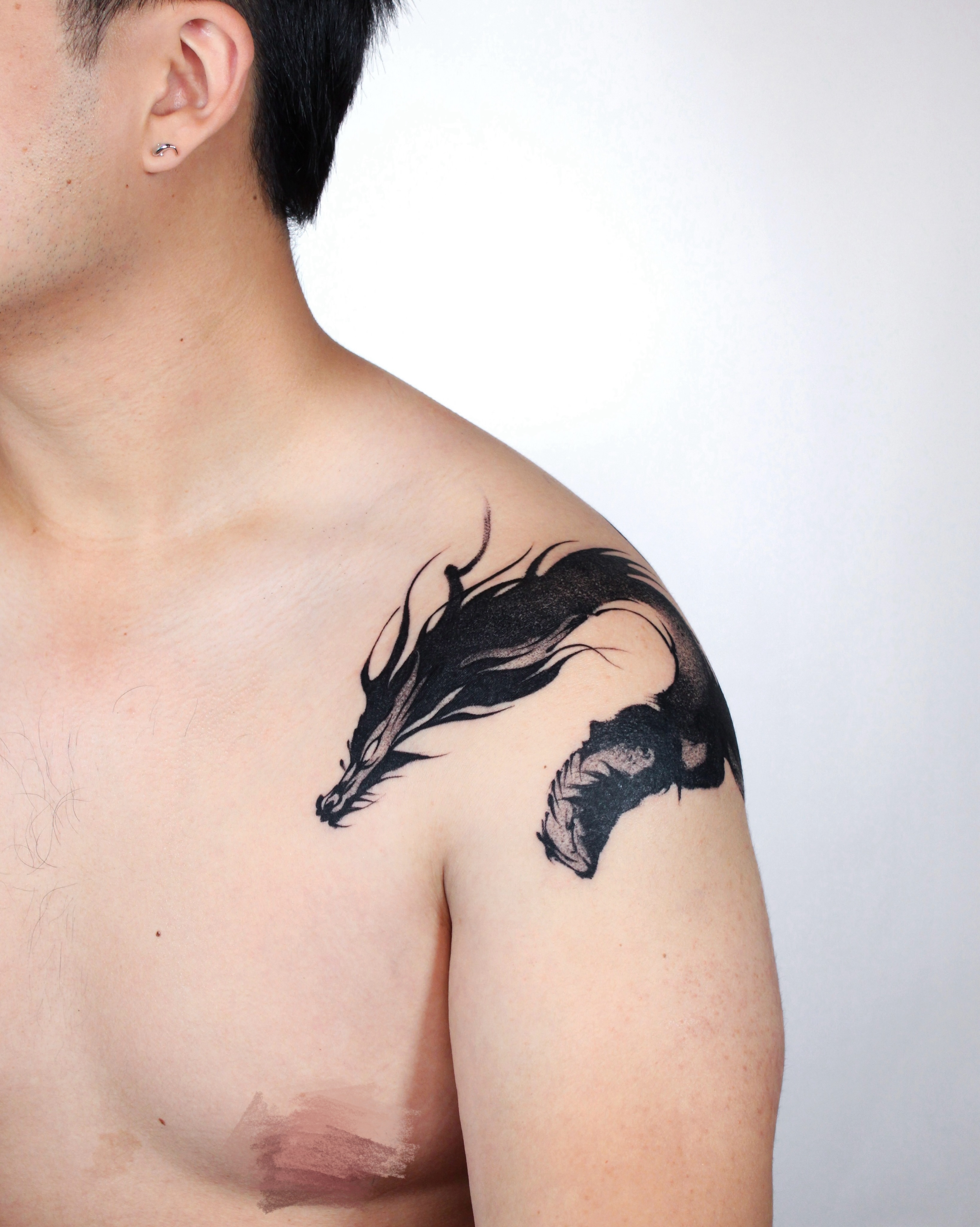 Dragon watercolor tattoo on the shoulder by Piao