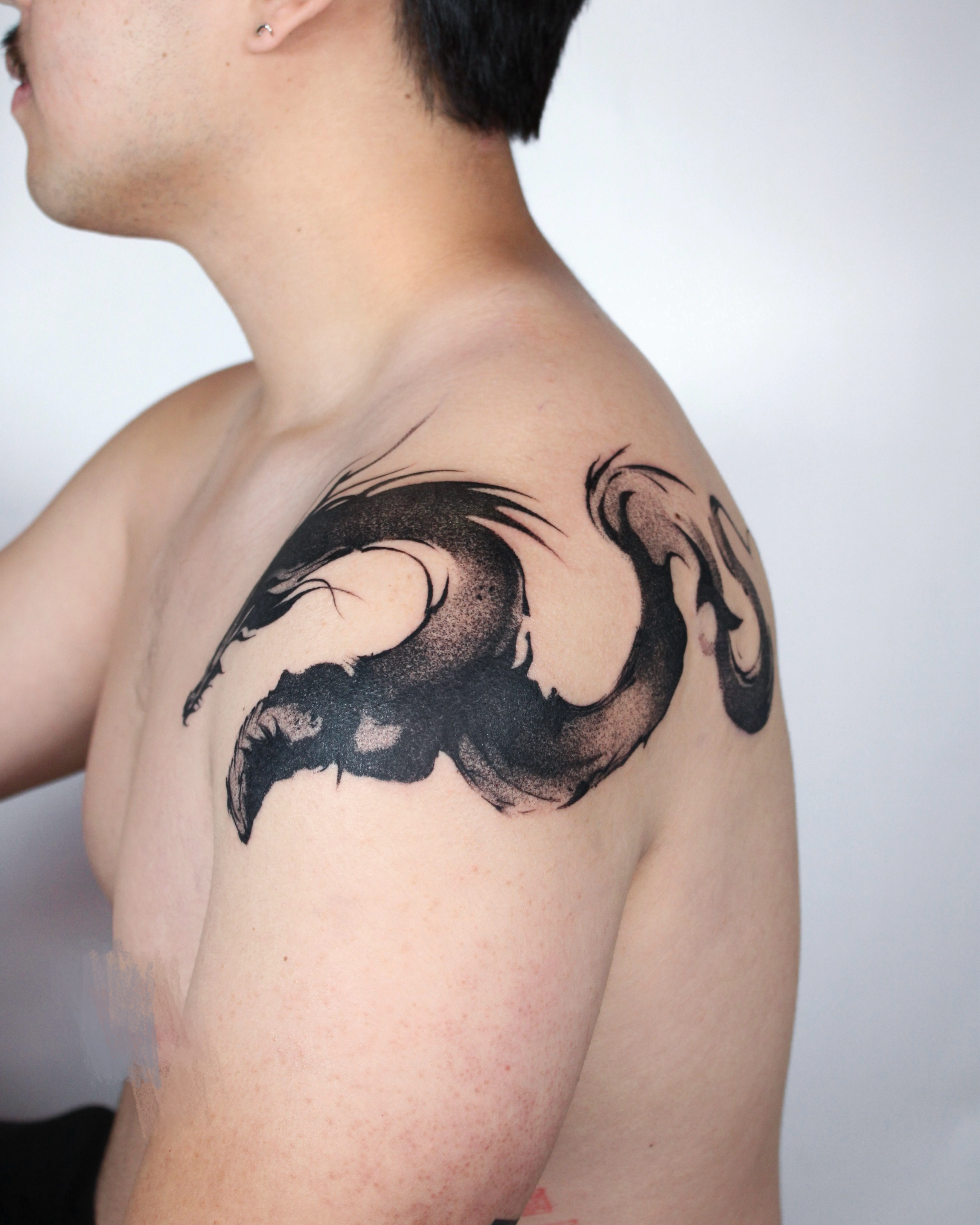 Dragon watercolor tattoo on the shoulder by Piao
