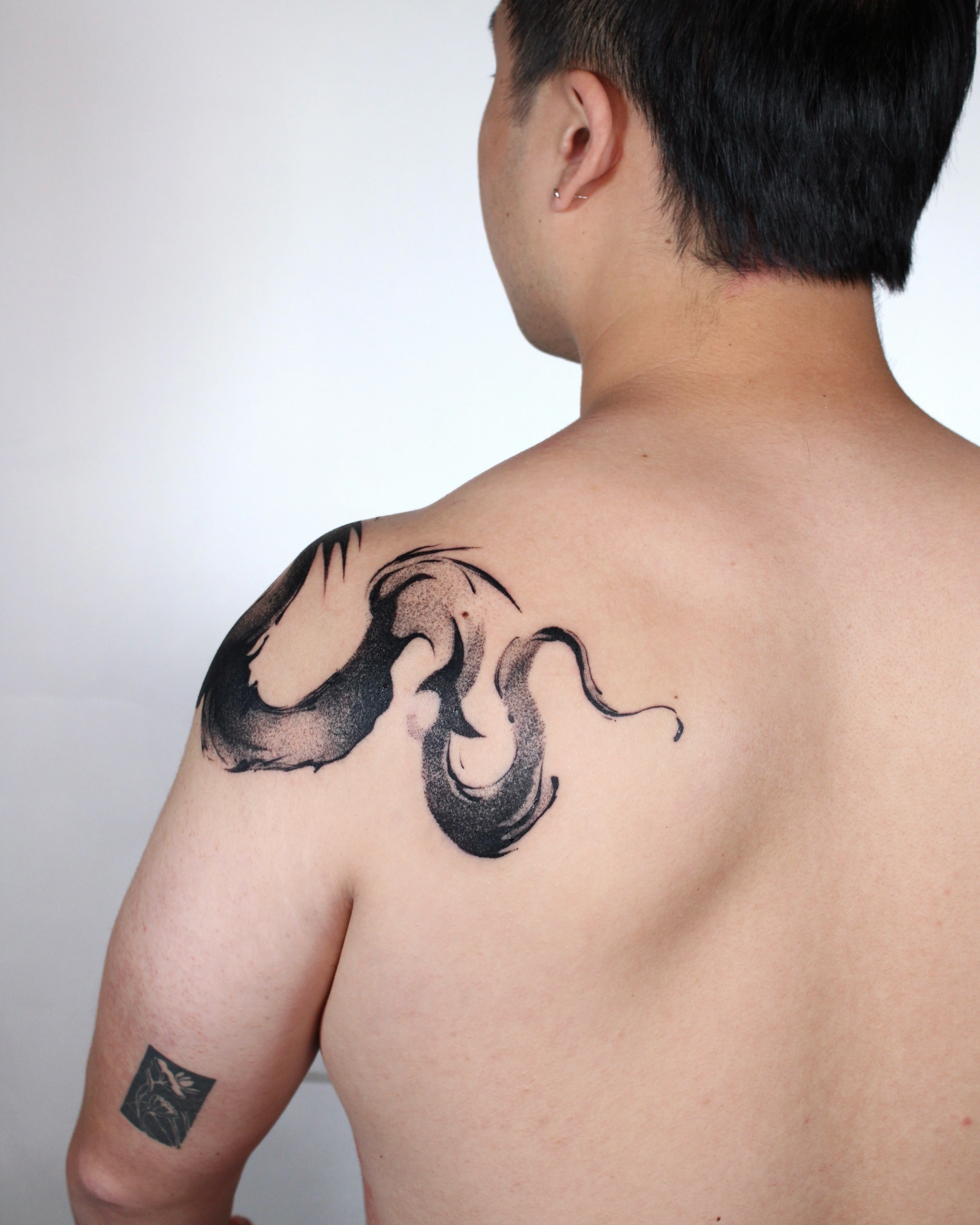 Dragon or serpent watercolor tattoo on the shoulder by Piao