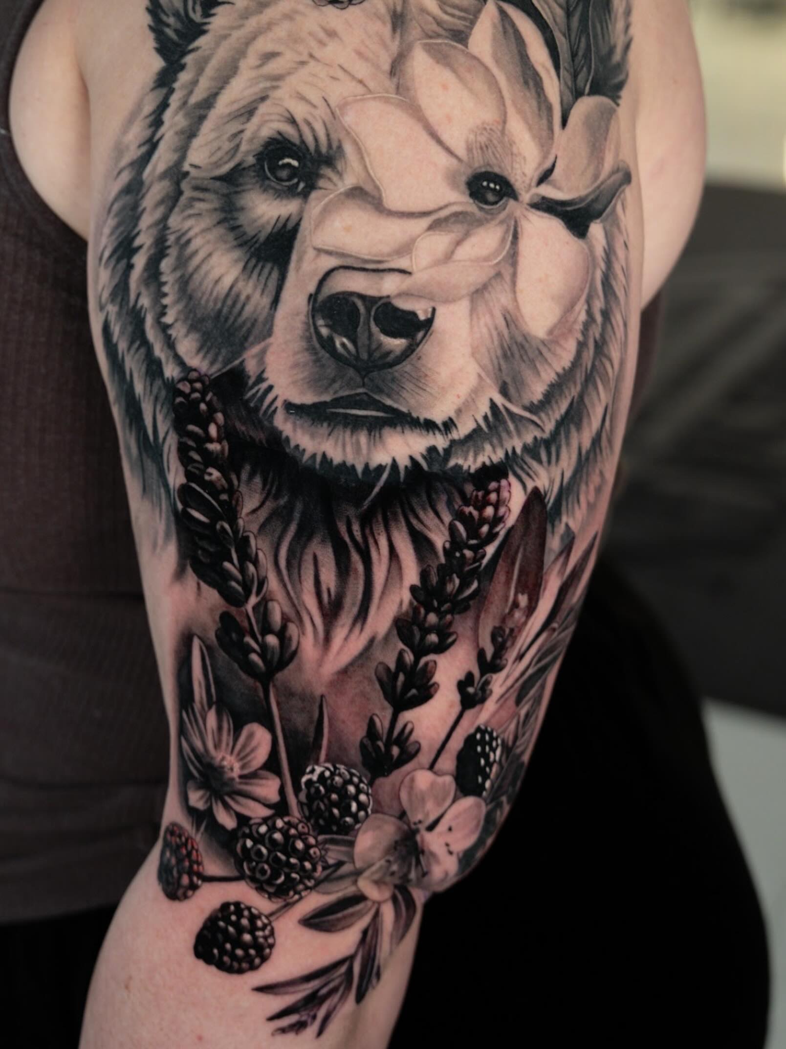 Bear with flowers realism tattoo on the forearm by Natalie Shaw