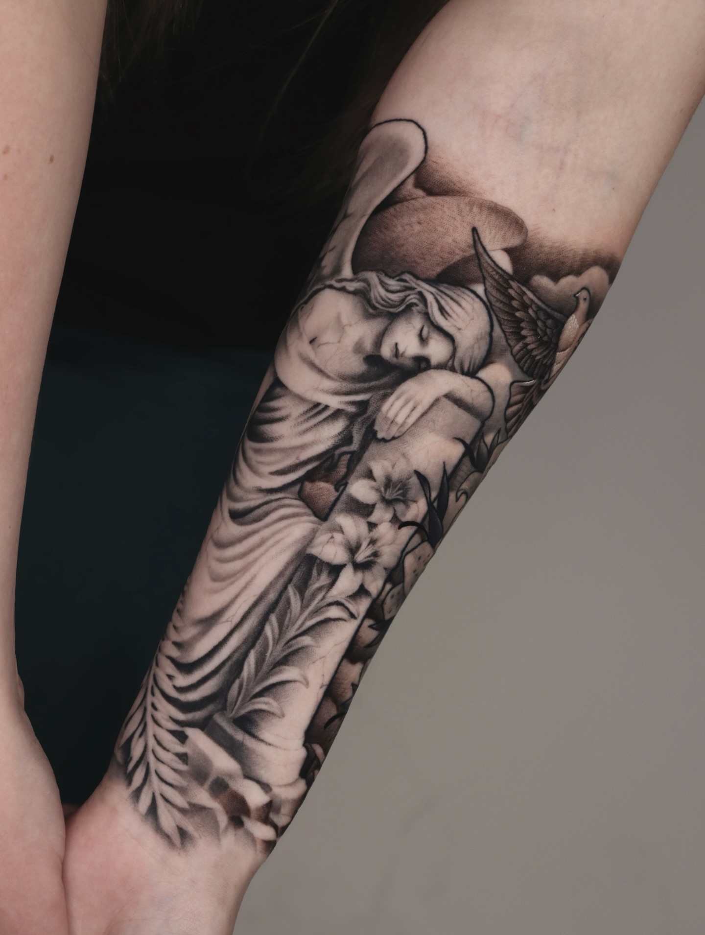 Sleeping angel realism tattoo on the forearm by Jeff Reindel