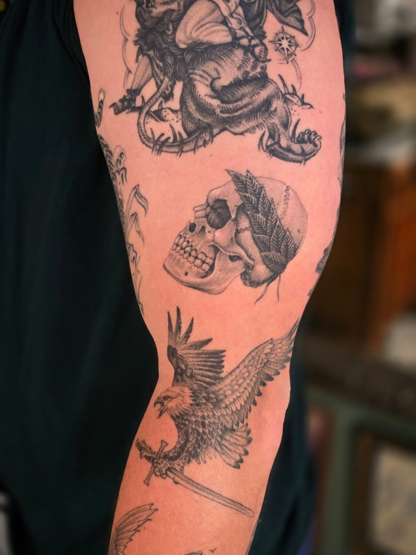 Lion, skull, eagle American traditional tattoo on the forearm by Aaron Dor