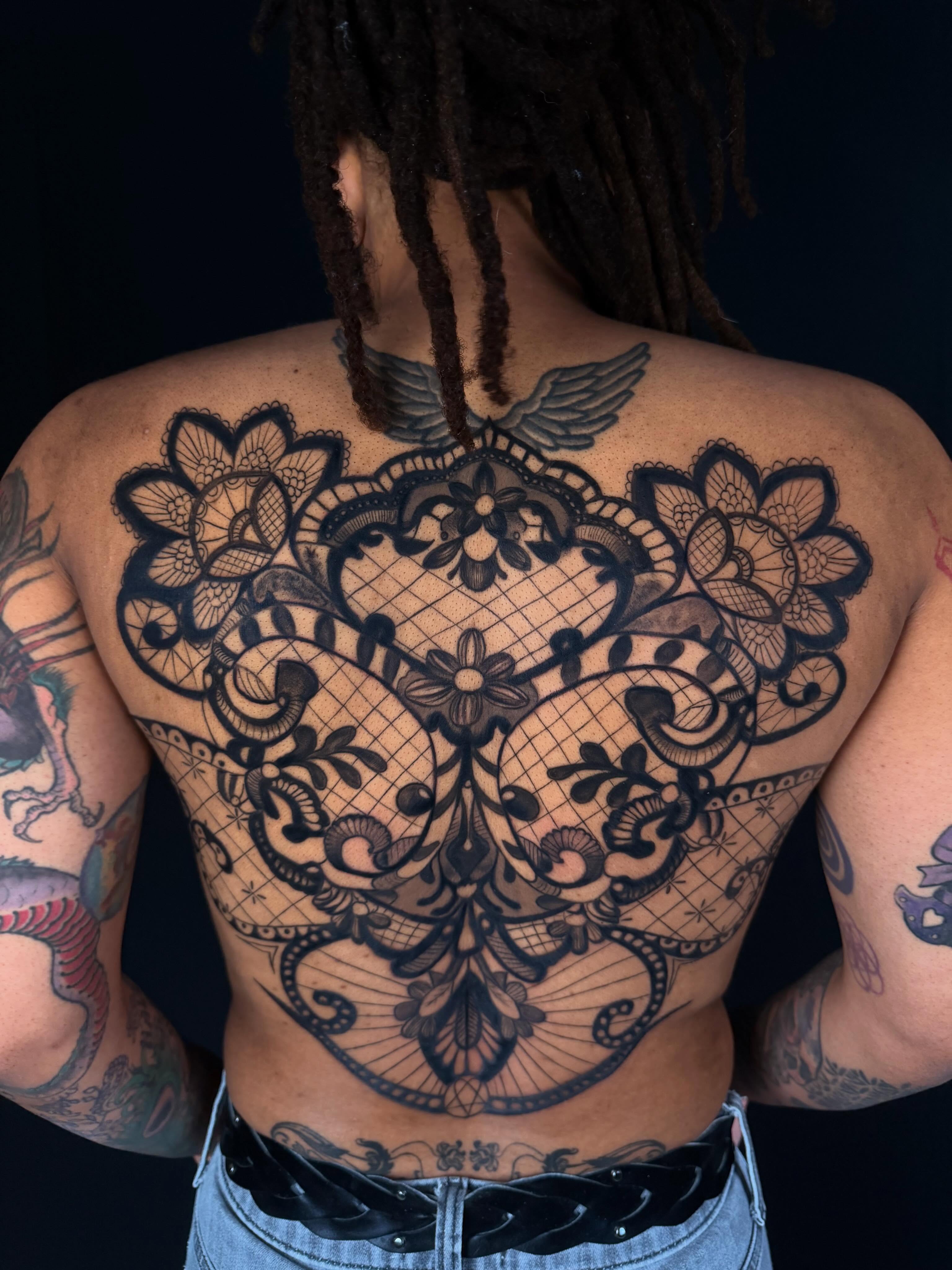 Lace pattern ornamental tattoo on the back by Idalia Pulido