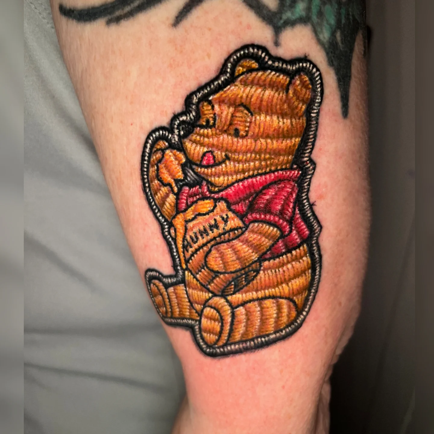 Winnie the Pooh American traditional tattoo on the forearm by Nason Dilts