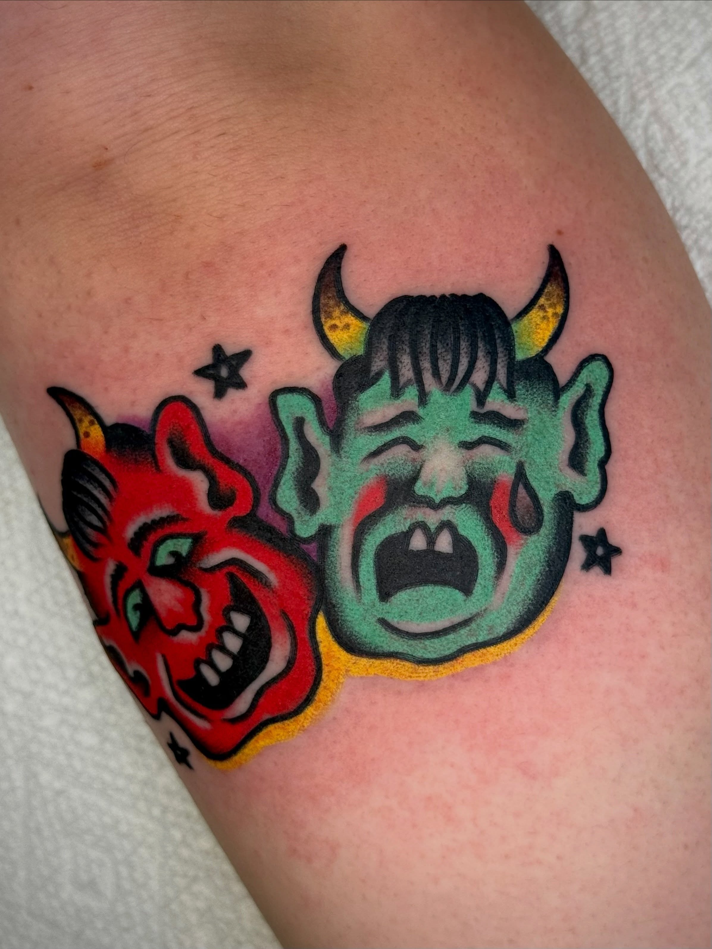 Demon faces American traditional tattoo on the thigh by Maximilian Harrison