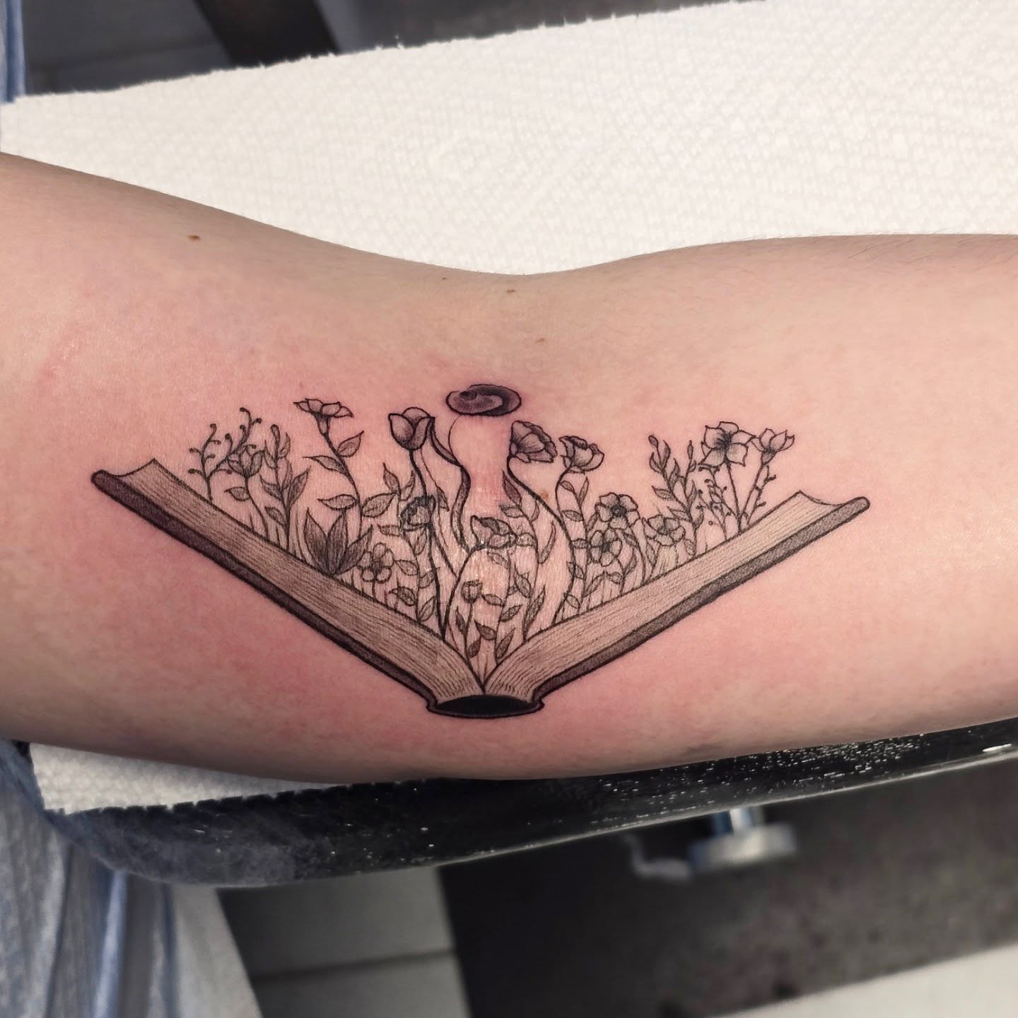 Book with flowers black and grey tattoo on the forearm by "Gentle"Jay Blondel