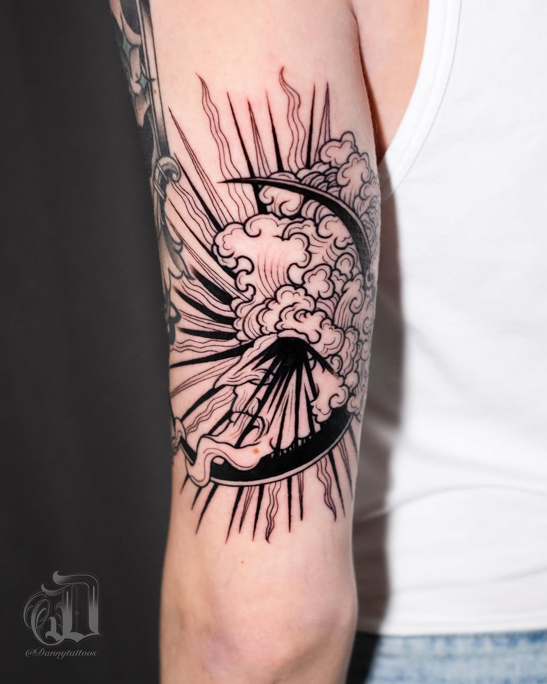 Volcano eruption black and grey tattoo on the forearm by Danny Pando