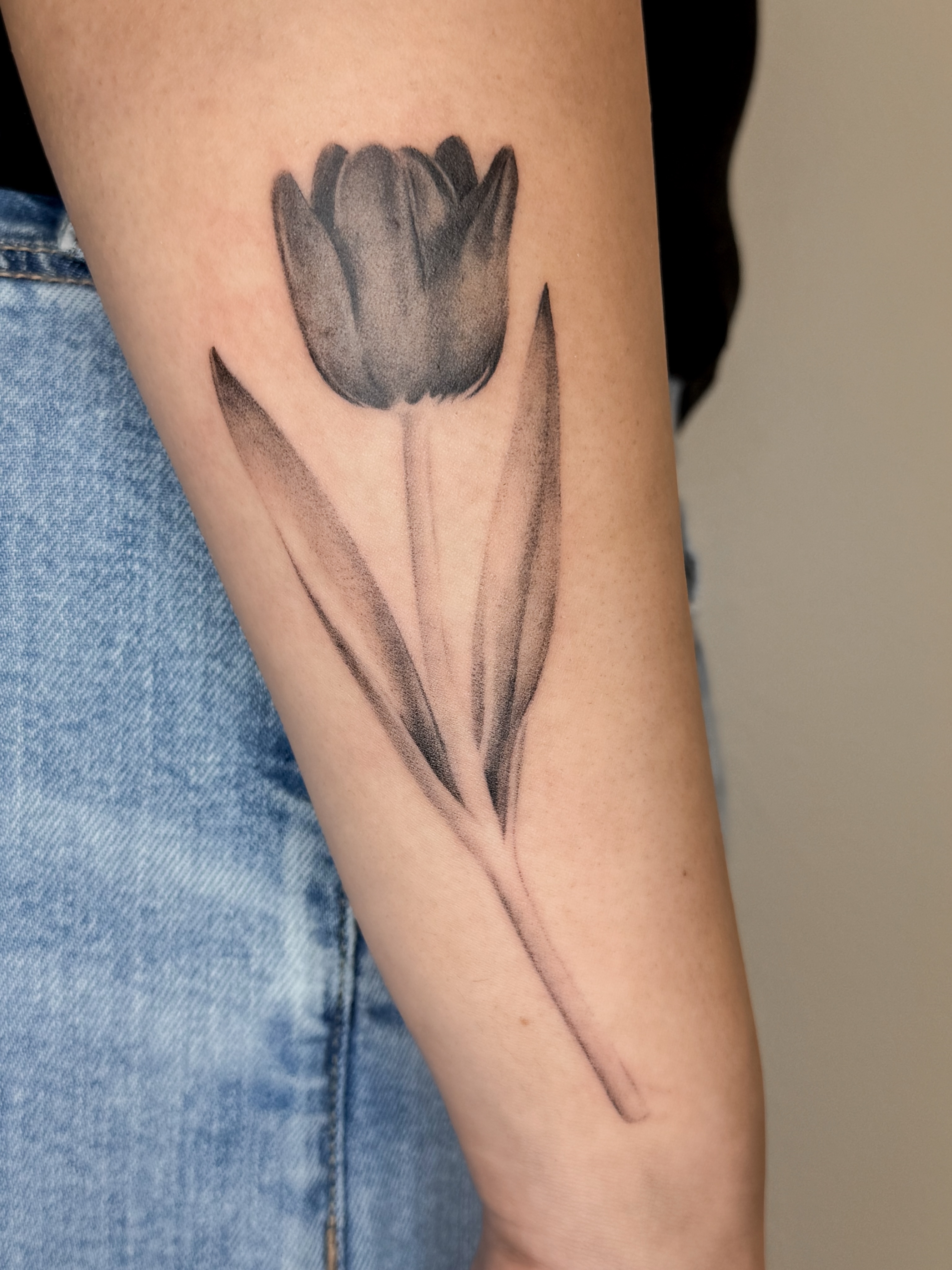 Tulip realism tattoo on the forearm by Rylee