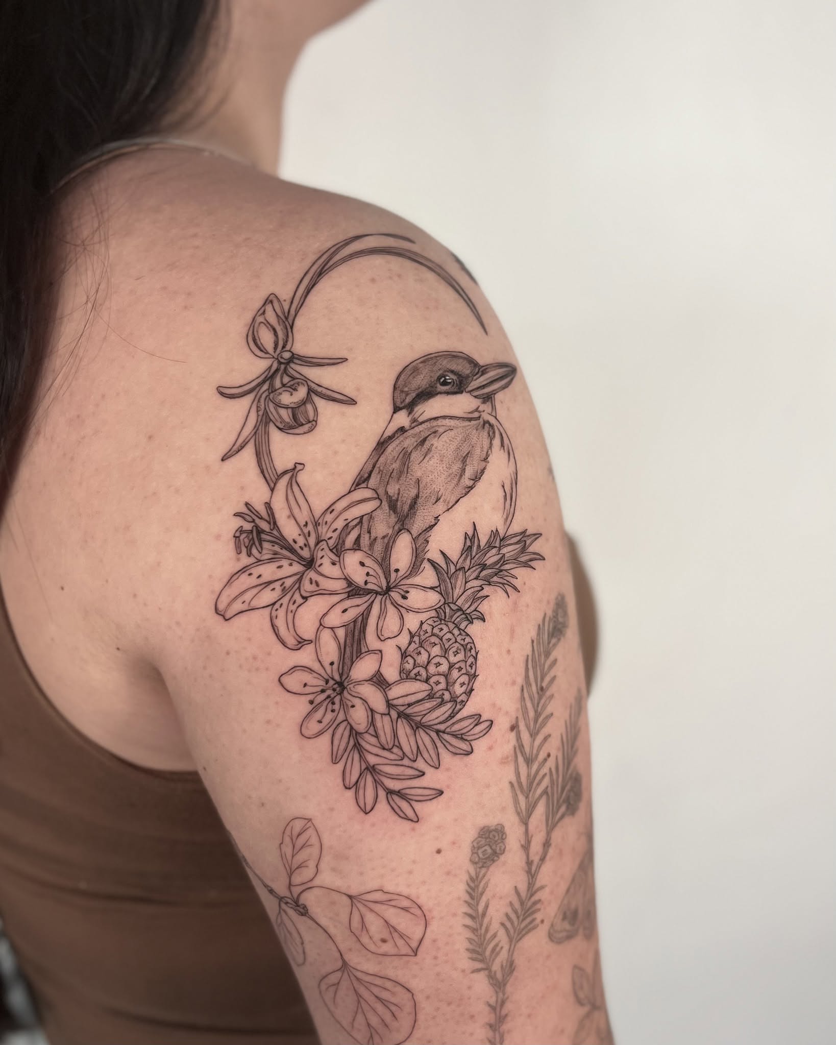 Bird and flowers black and grey tattoo on the shoulder by Sierra Skye
