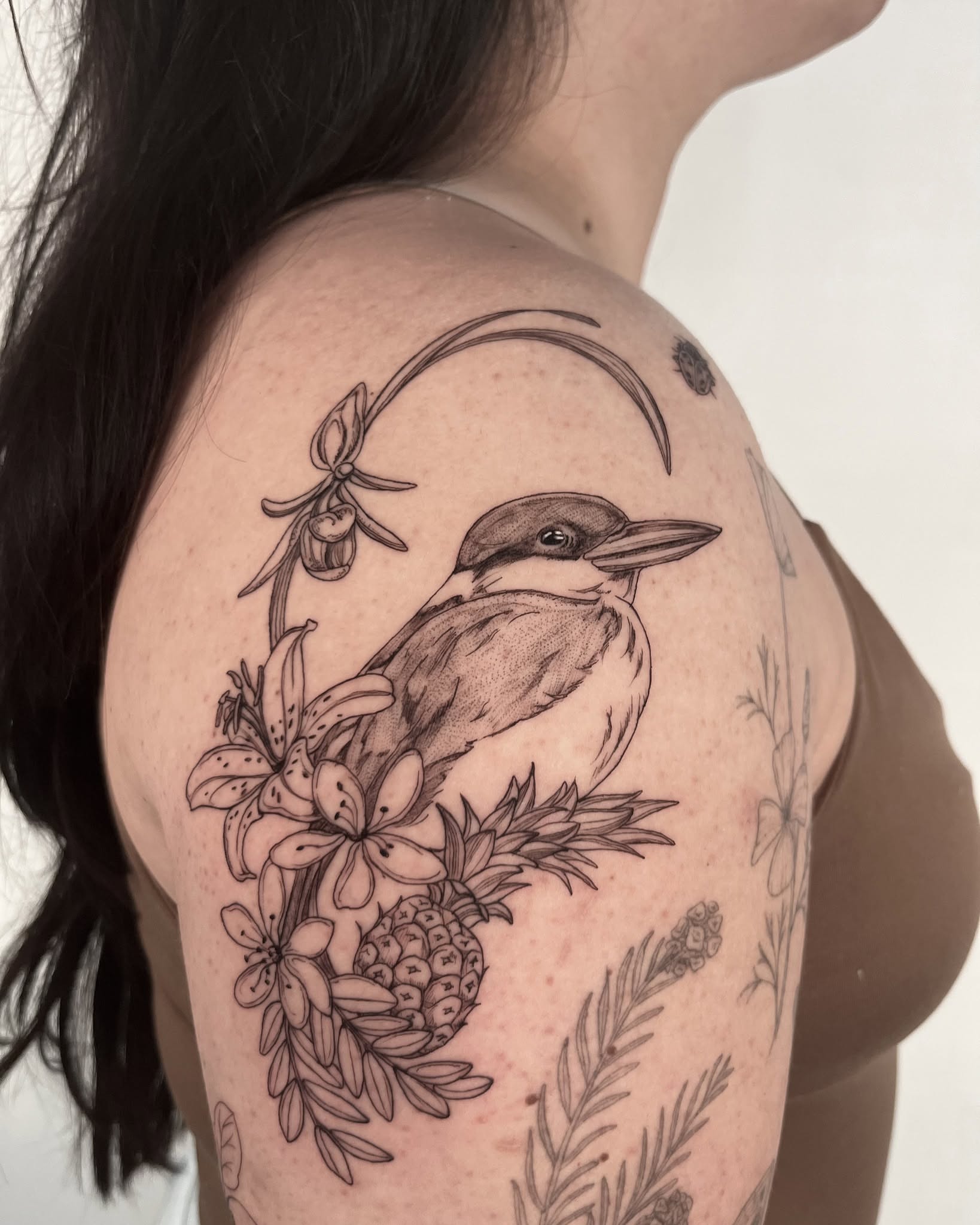 Bird and floral arrangement realism tattoo on the shoulder by Sierra Skye