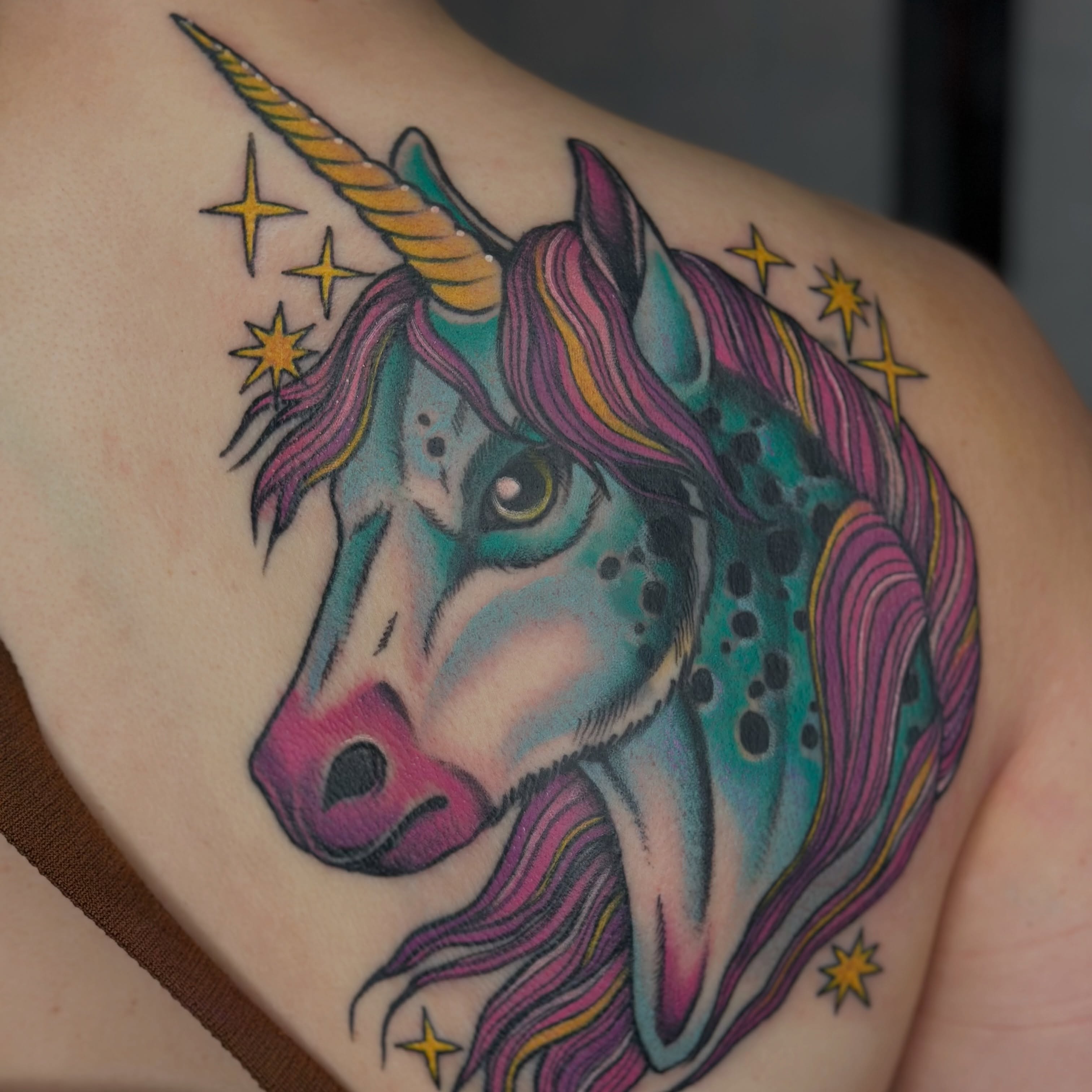 Unicorn new school tattoo on the shoulder by Sarah Christine Tattoo, Calgary, Alberta