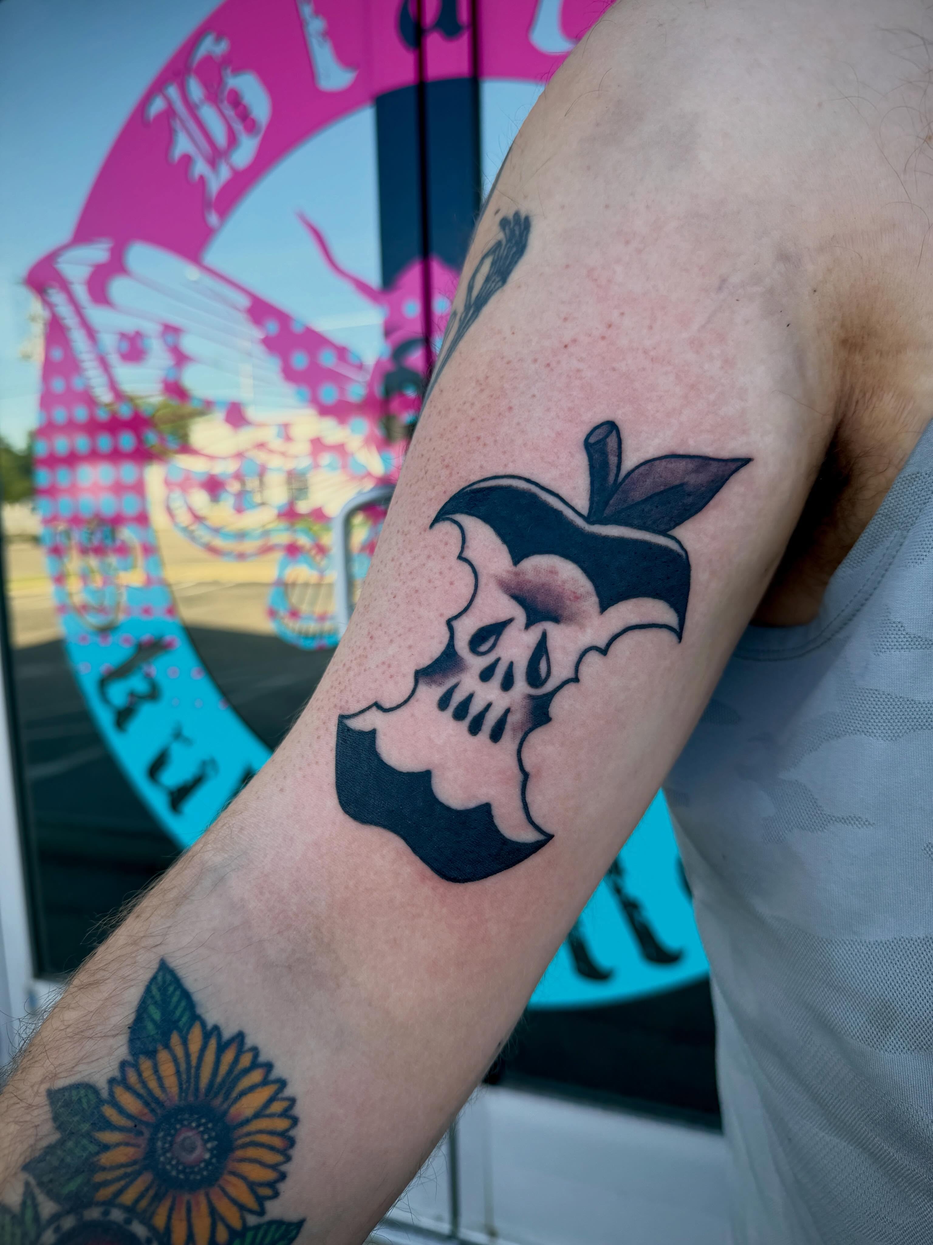 Apple skull black and grey tattoo on the forearm by Ali Calis