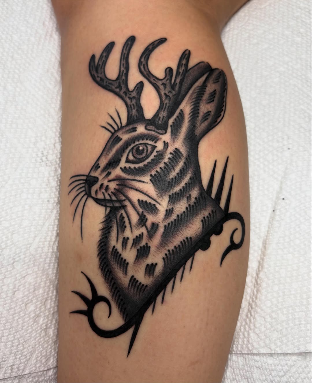 Deer head black and grey tattoo on the forearm by Izzy
