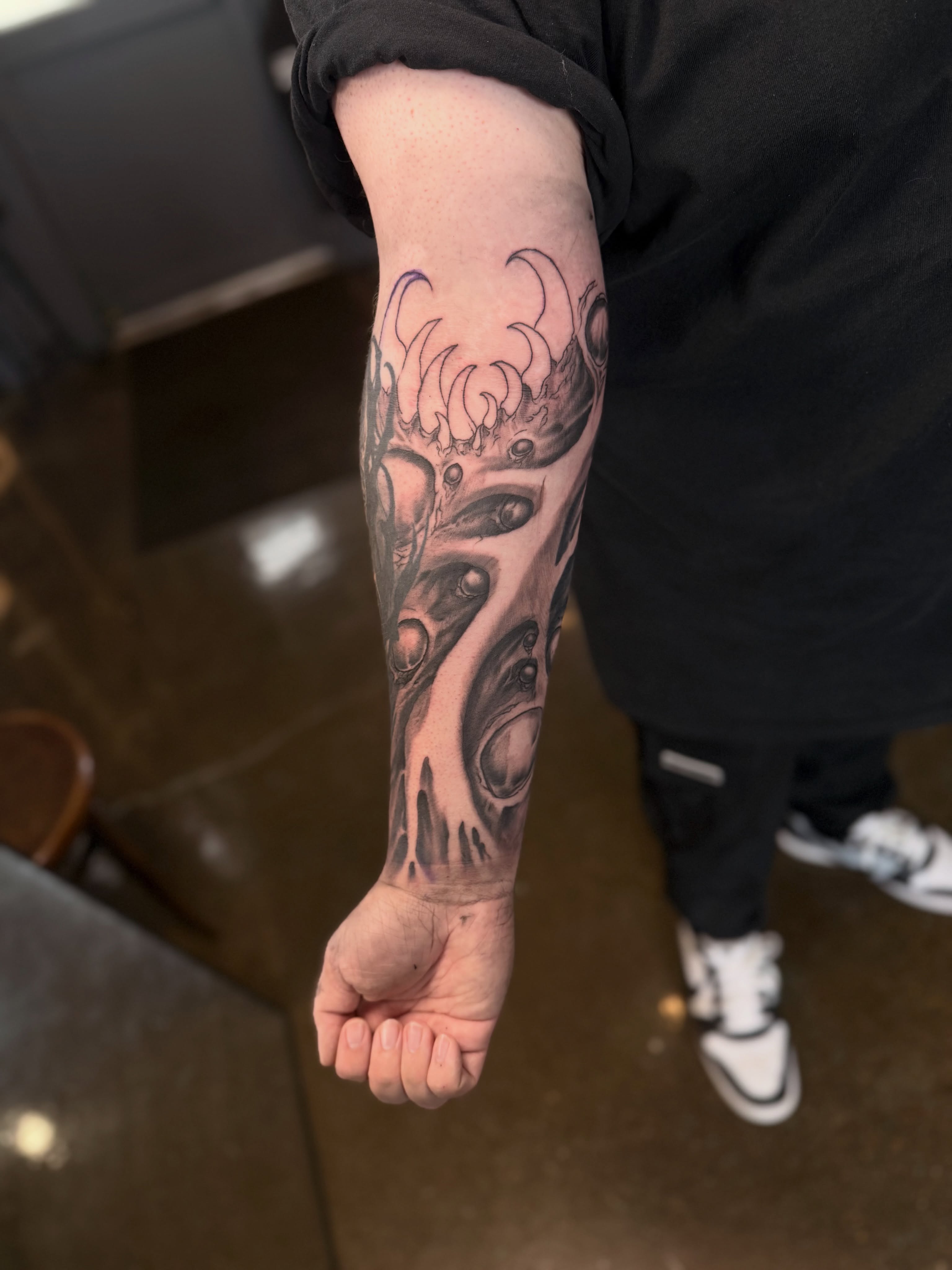 Abstract biomechanical design surrealism tattoo on the forearm by Miles Haysmith
