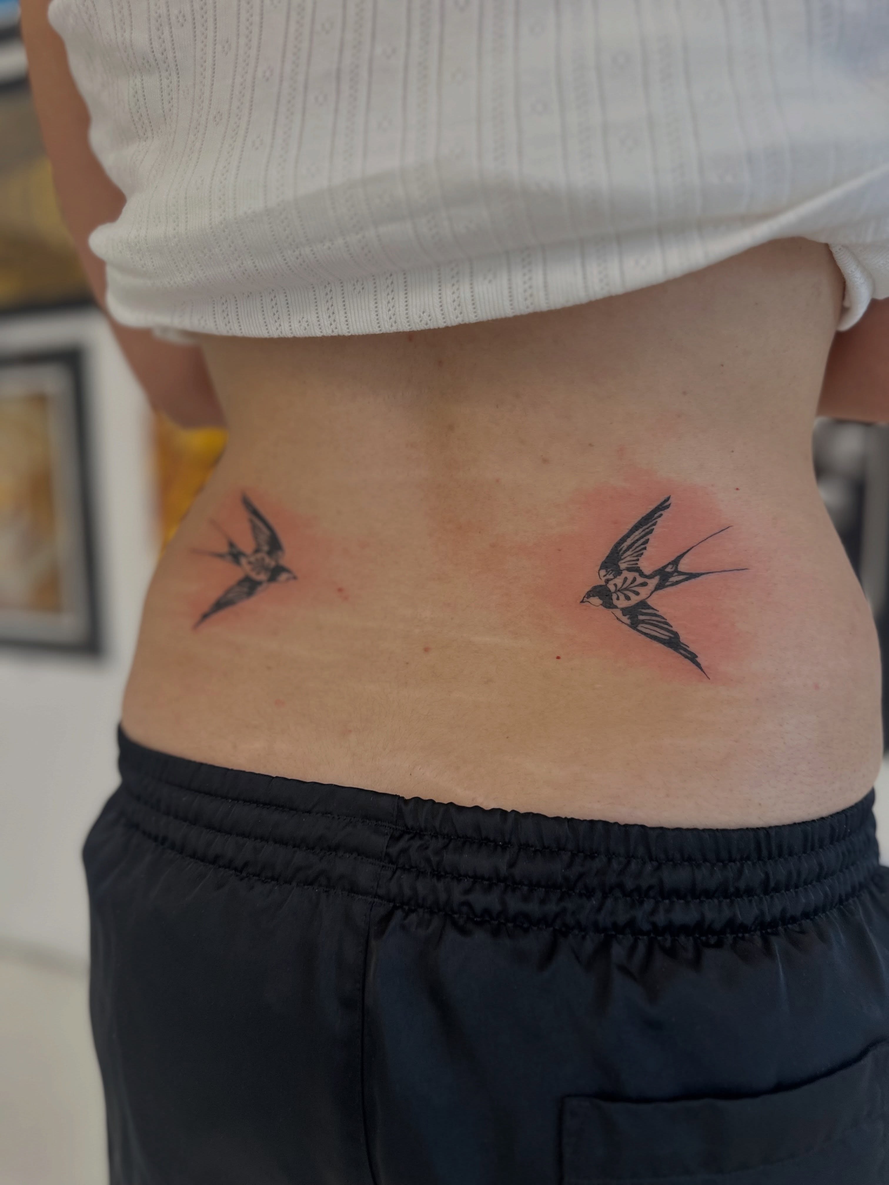 Swallows black and grey tattoo on the torso by Ric Castellon Tattoo Artist, Los Angeles, California
