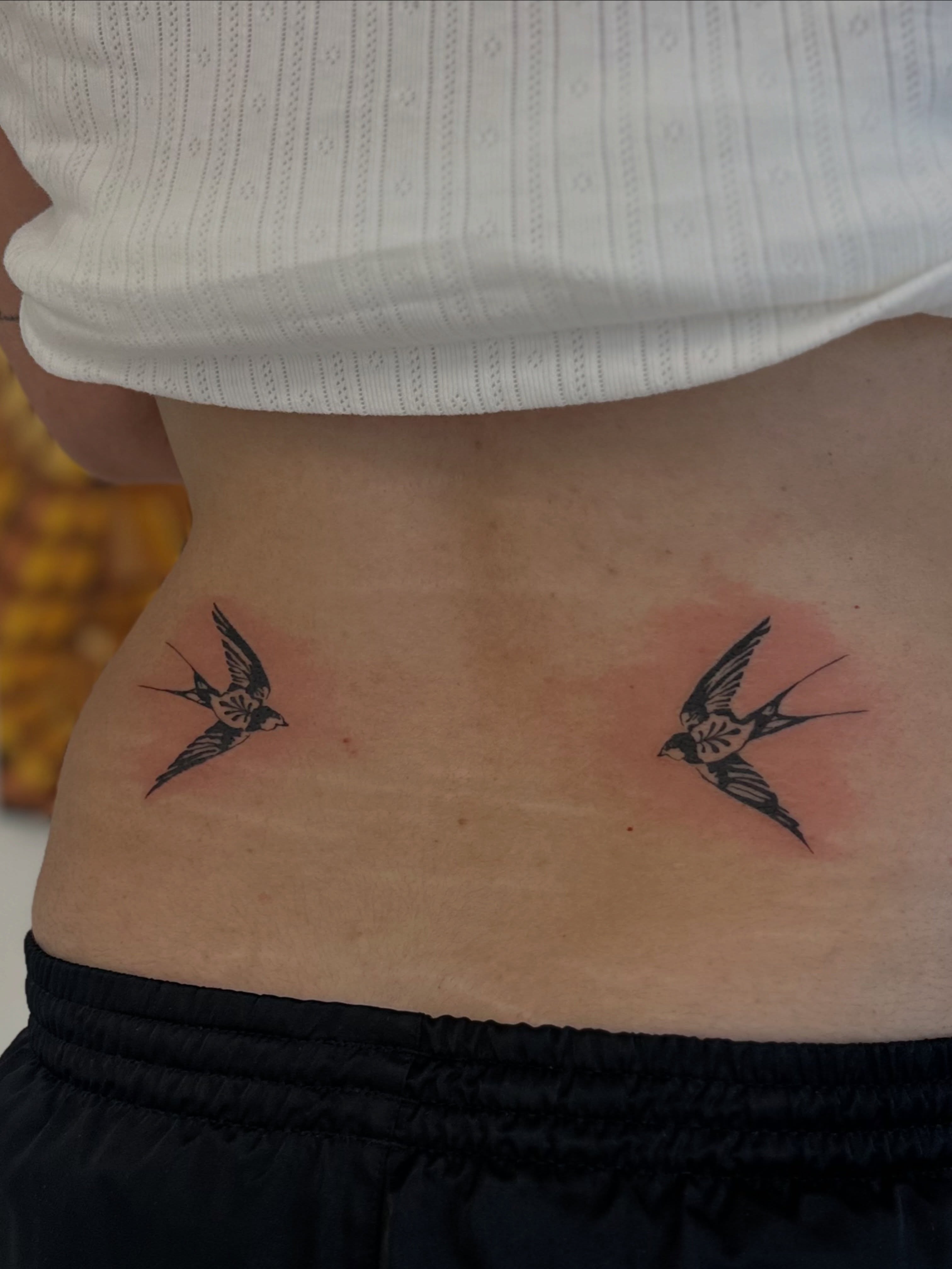 Swallows black and grey tattoo on the torso by Ric Castellon Tattoo Artist, Los Angeles, California