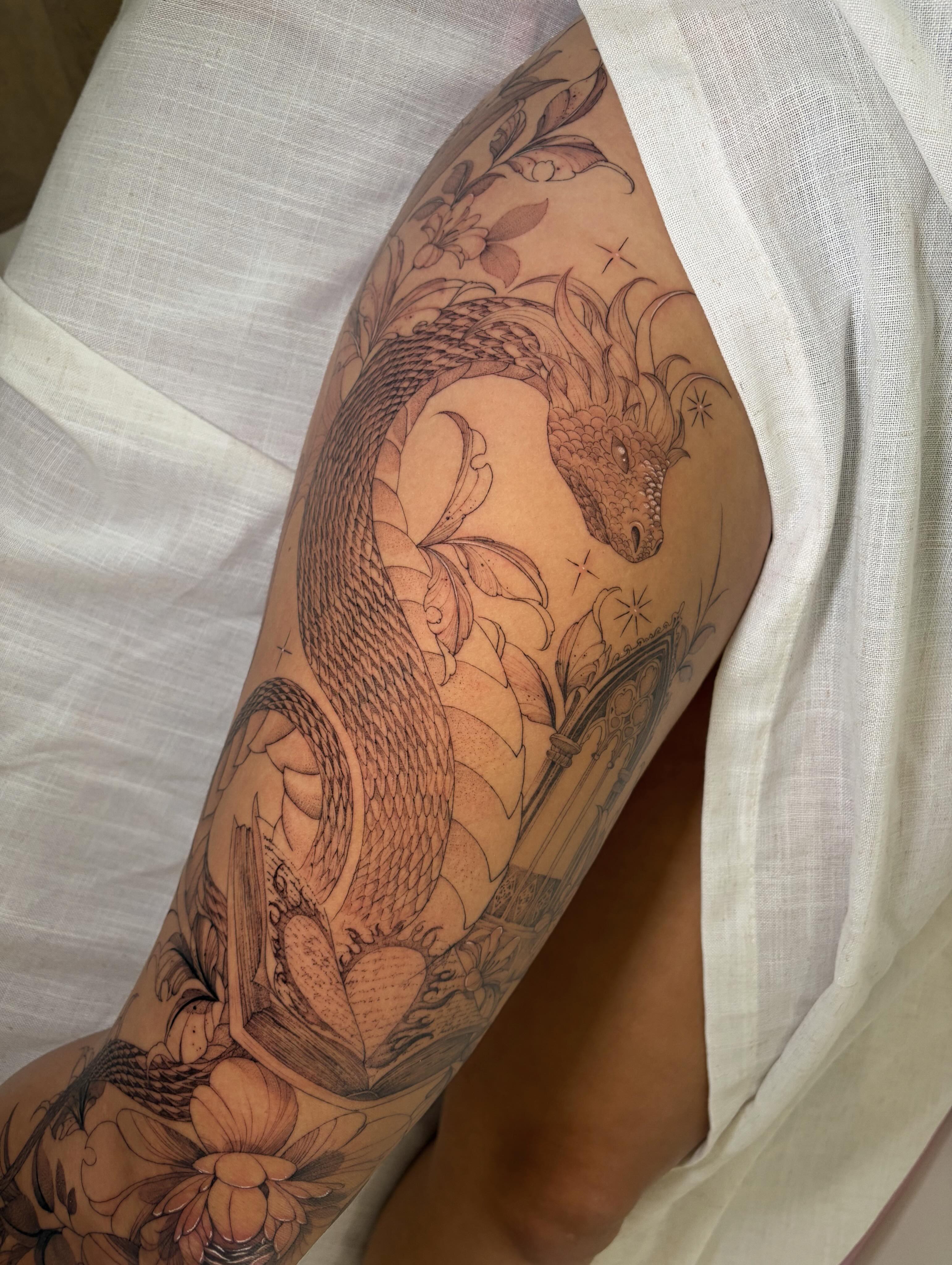 Dragon and floral black and grey tattoo on the upper arm by Justene Renee 🖤 Fine Line Tattoo Artist