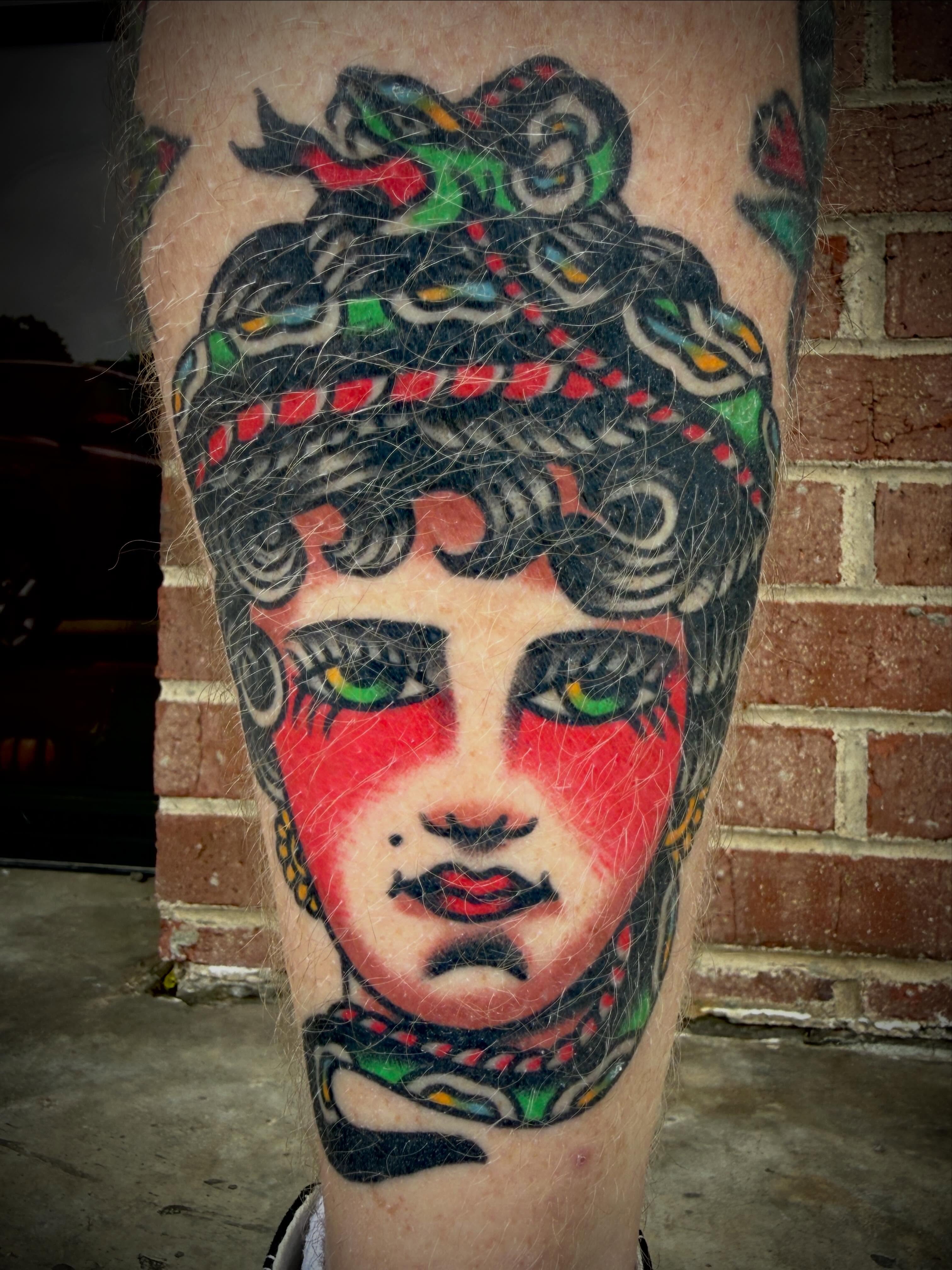 Theater mask American traditional tattoo on the forearm by Tristan Bradshaw