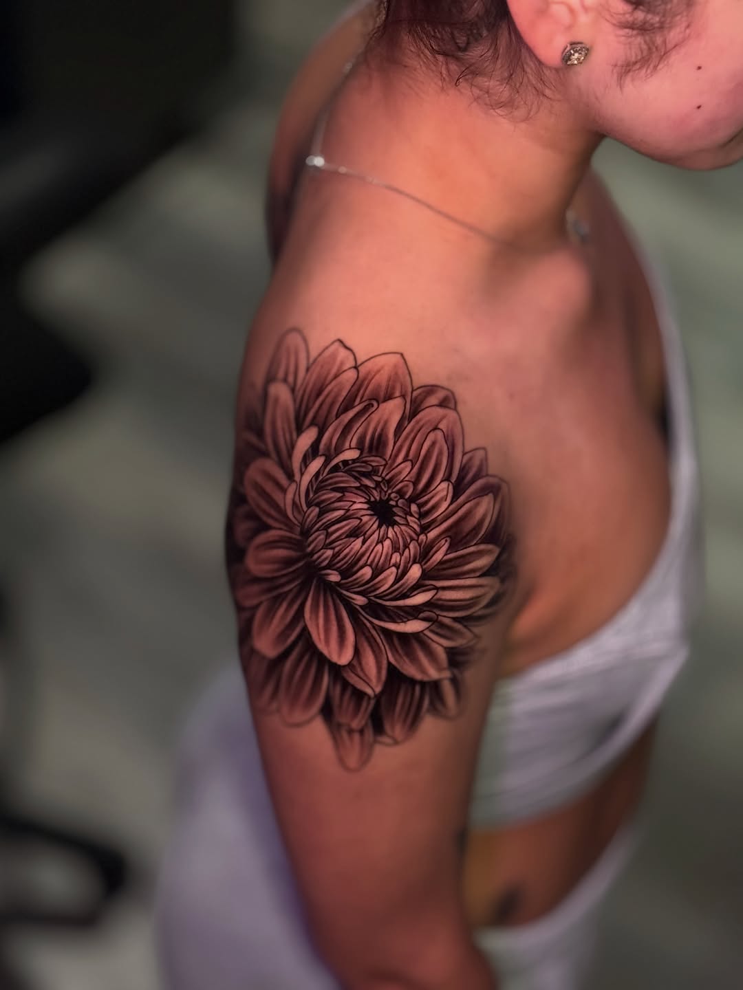 Chrysanthemum flower fine line tattoo on the shoulder by Miguel Garcia