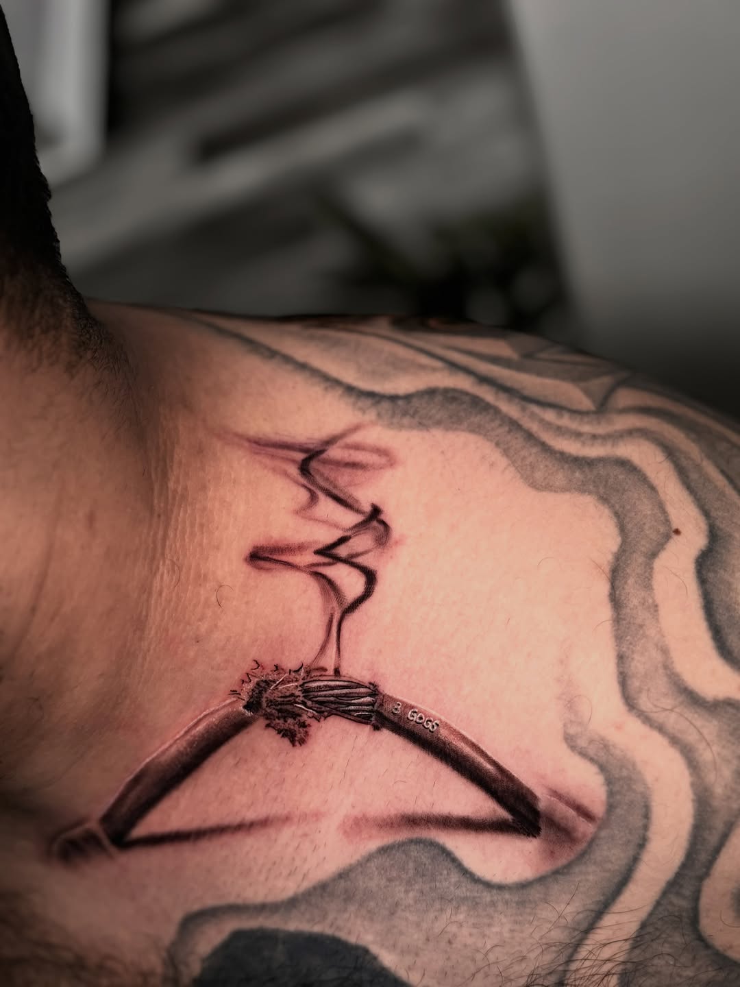 Broken electrical wire with smoke surrealism tattoo on the back by Miguel Garcia