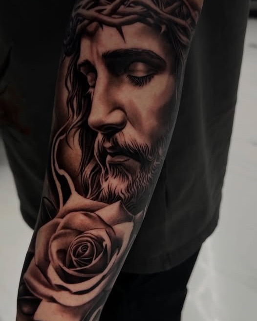 Jesus Christ with rose realism tattoo on the forearm by Ivan Guadalupe guzman