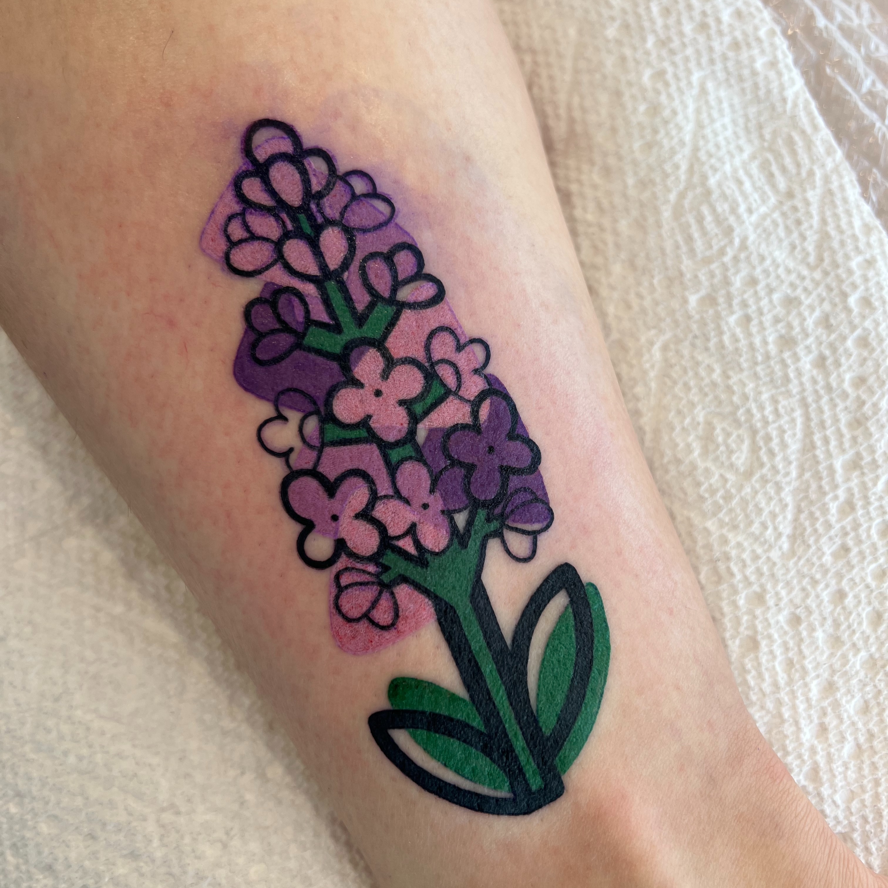 Lavender bouquet new school tattoo on the forearm by Tattoo Artist