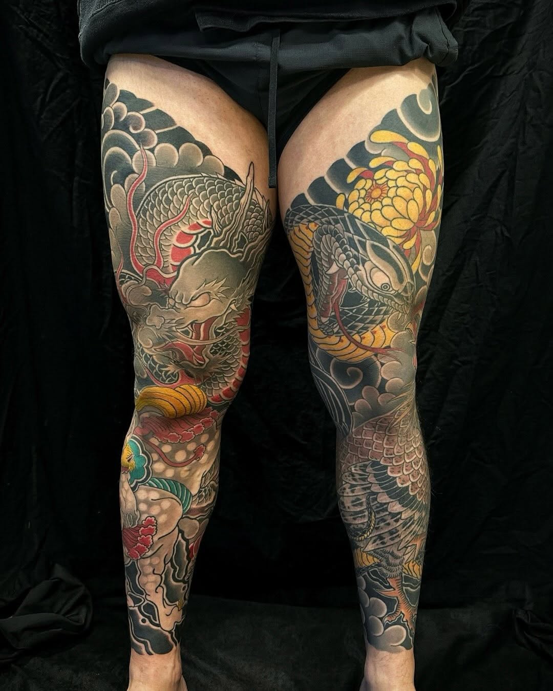 Dragon and snake with chrysanthemum Japanese tattoo on the leg by Xiaojun Yin, Vancouver, British Columbia