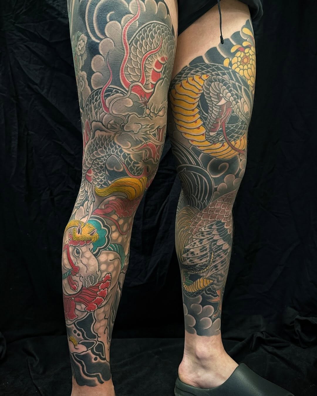 Dragon, snake, and mythical creature Japanese tattoo on the leg by Xiaojun Yin, Vancouver, British Columbia