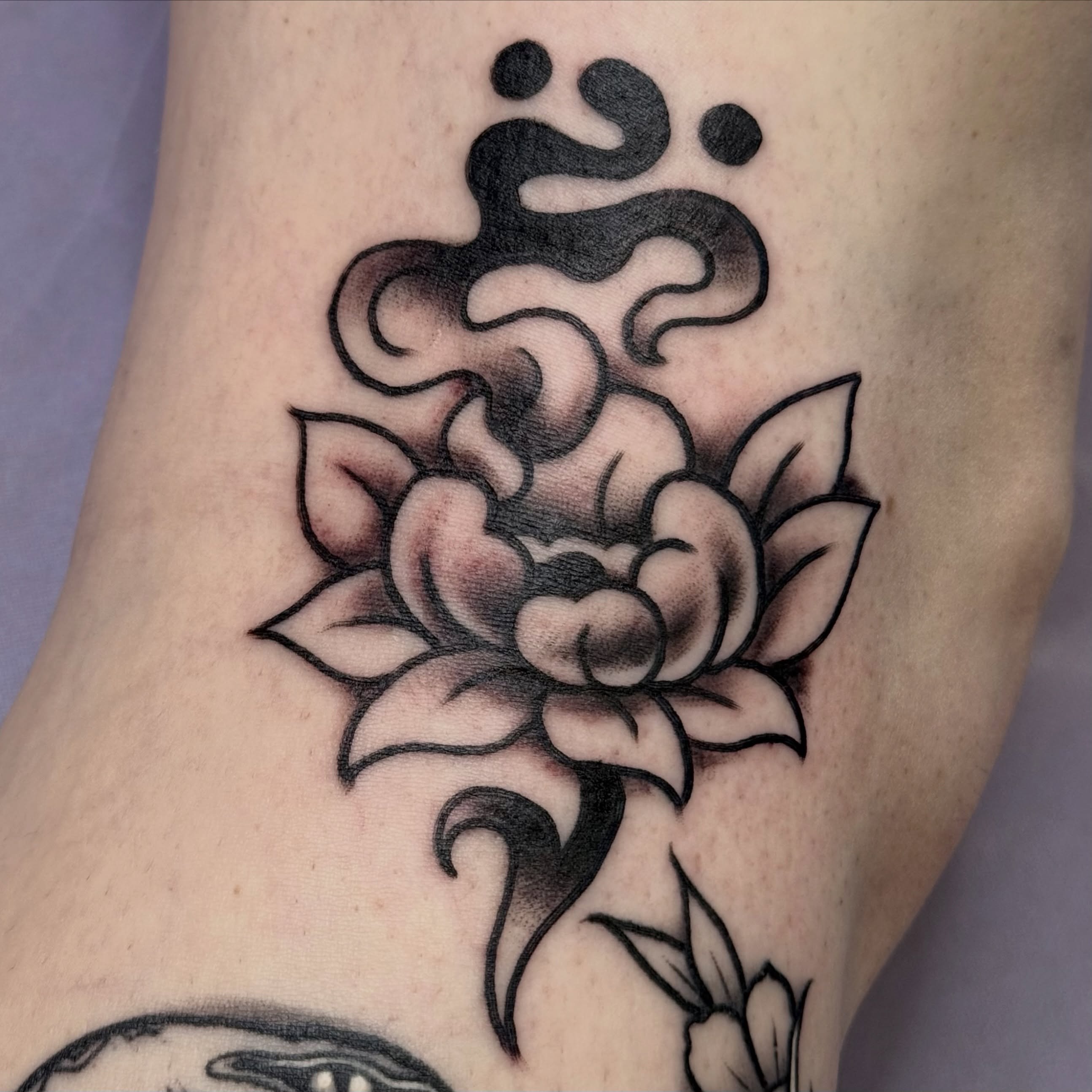 Lotus flower black and grey tattoo on the forearm by Chelsea Graham, Seattle, Washington