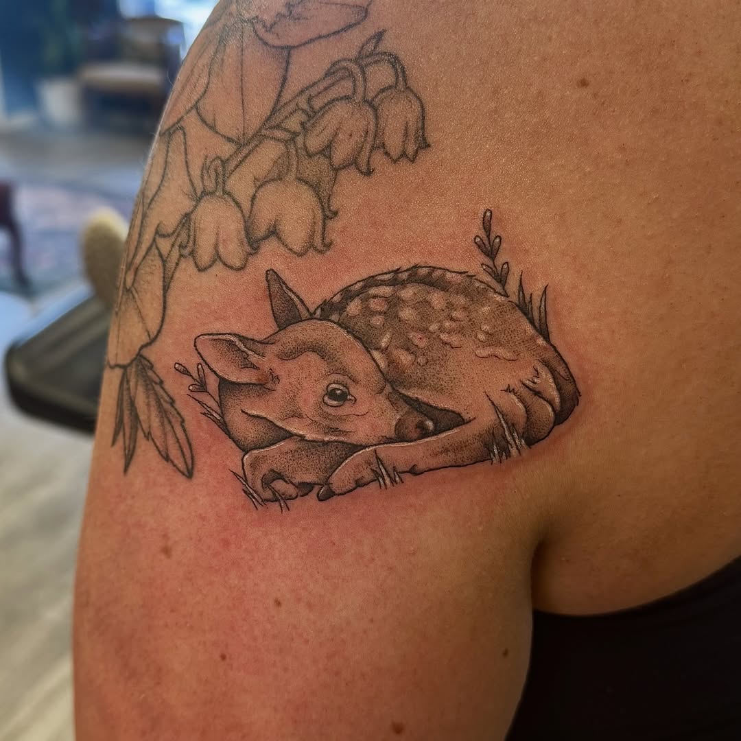 Deer and lilies of the valley realism tattoo on the shoulder by Kat Bennett