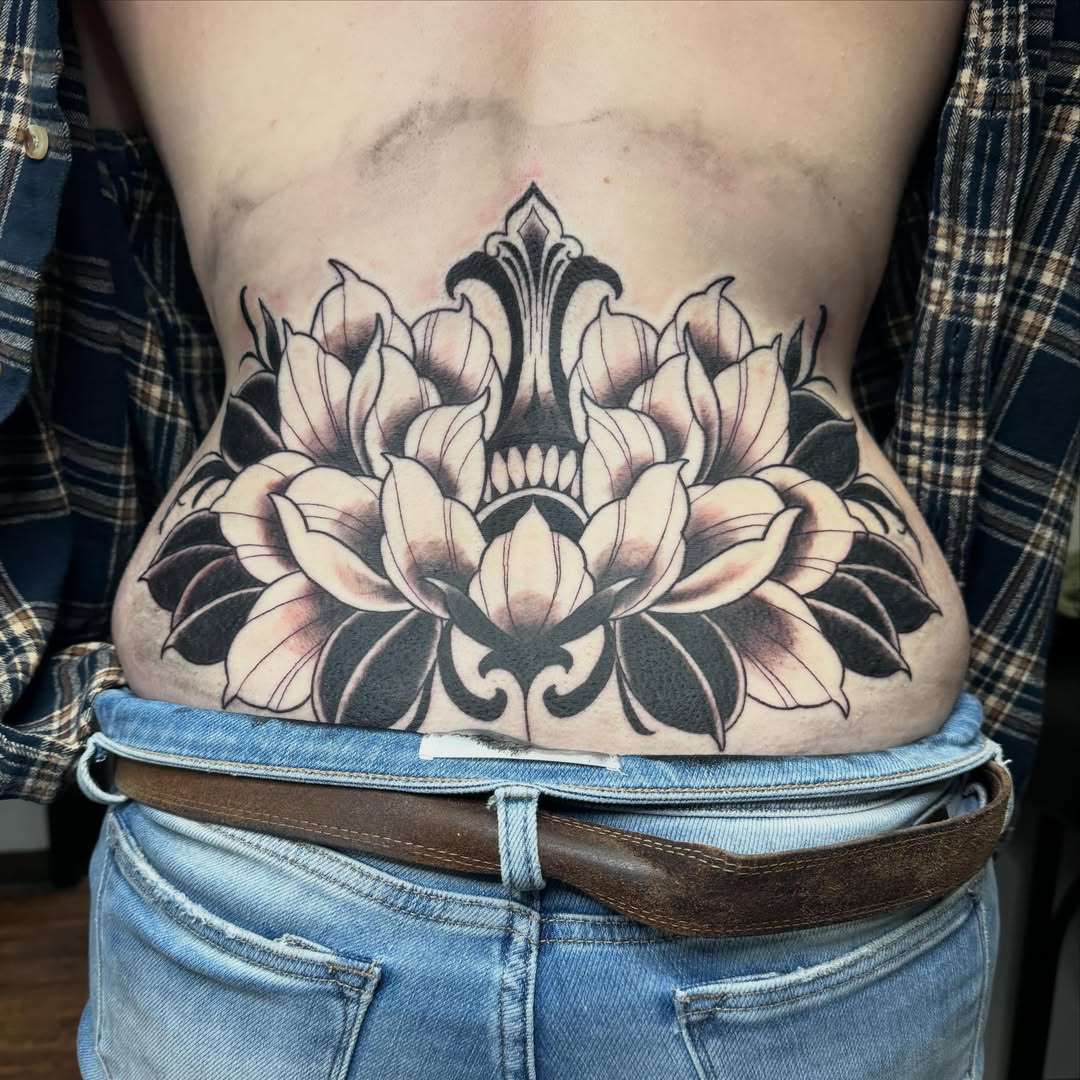 Lotus flower black and grey tattoo on the ribs by Kyle Holt