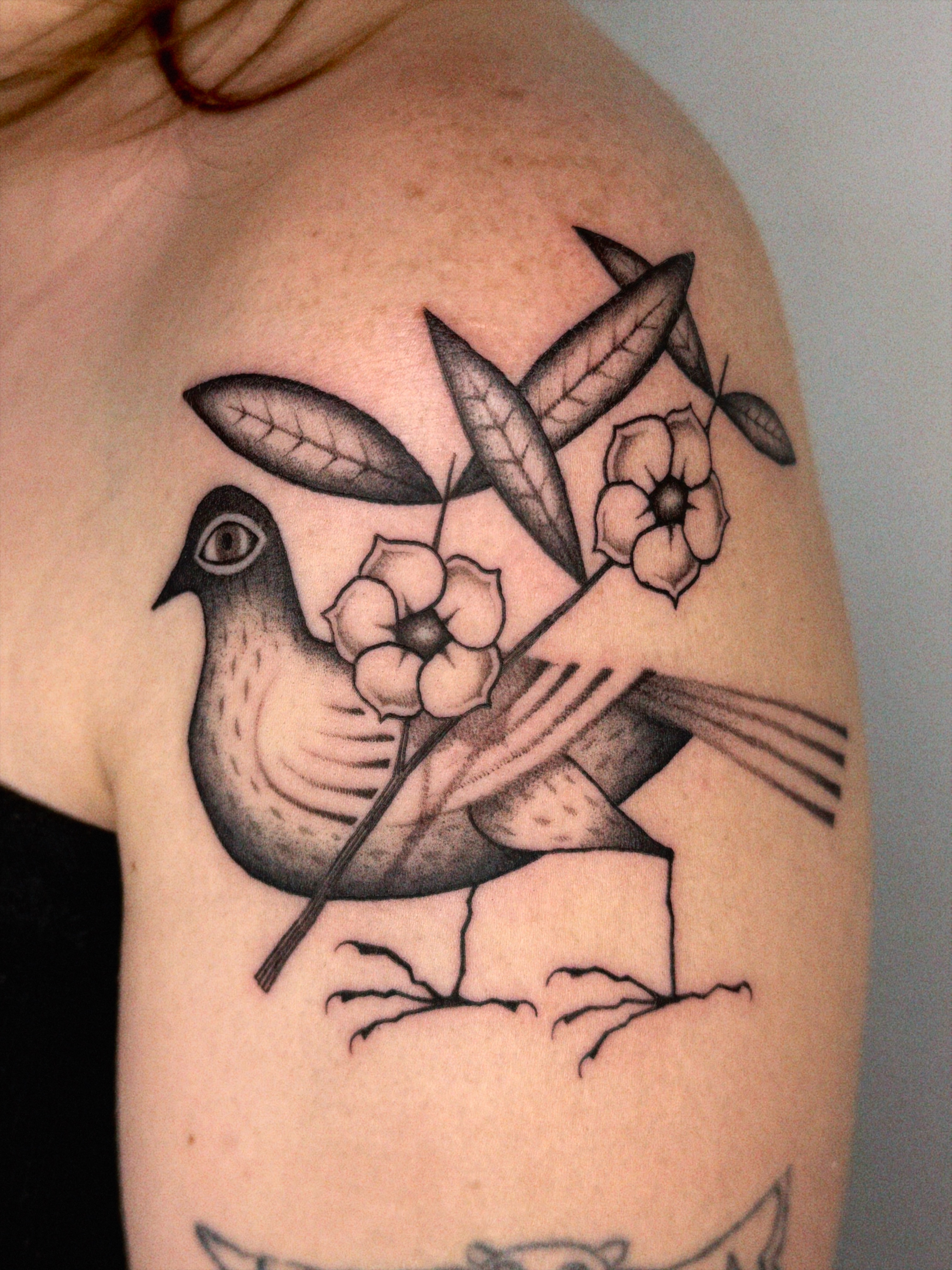Bird with flowers black and grey tattoo on the shoulder by @inkshame
