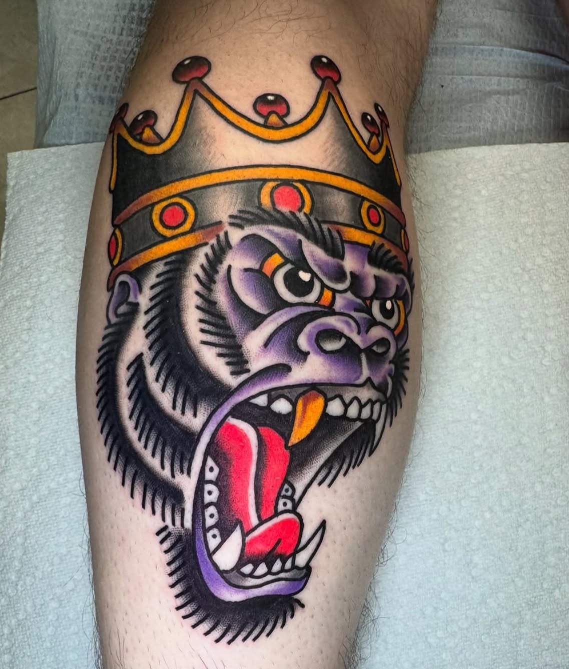 Gorilla crown American traditional tattoo on the leg by Kenneth Gibson