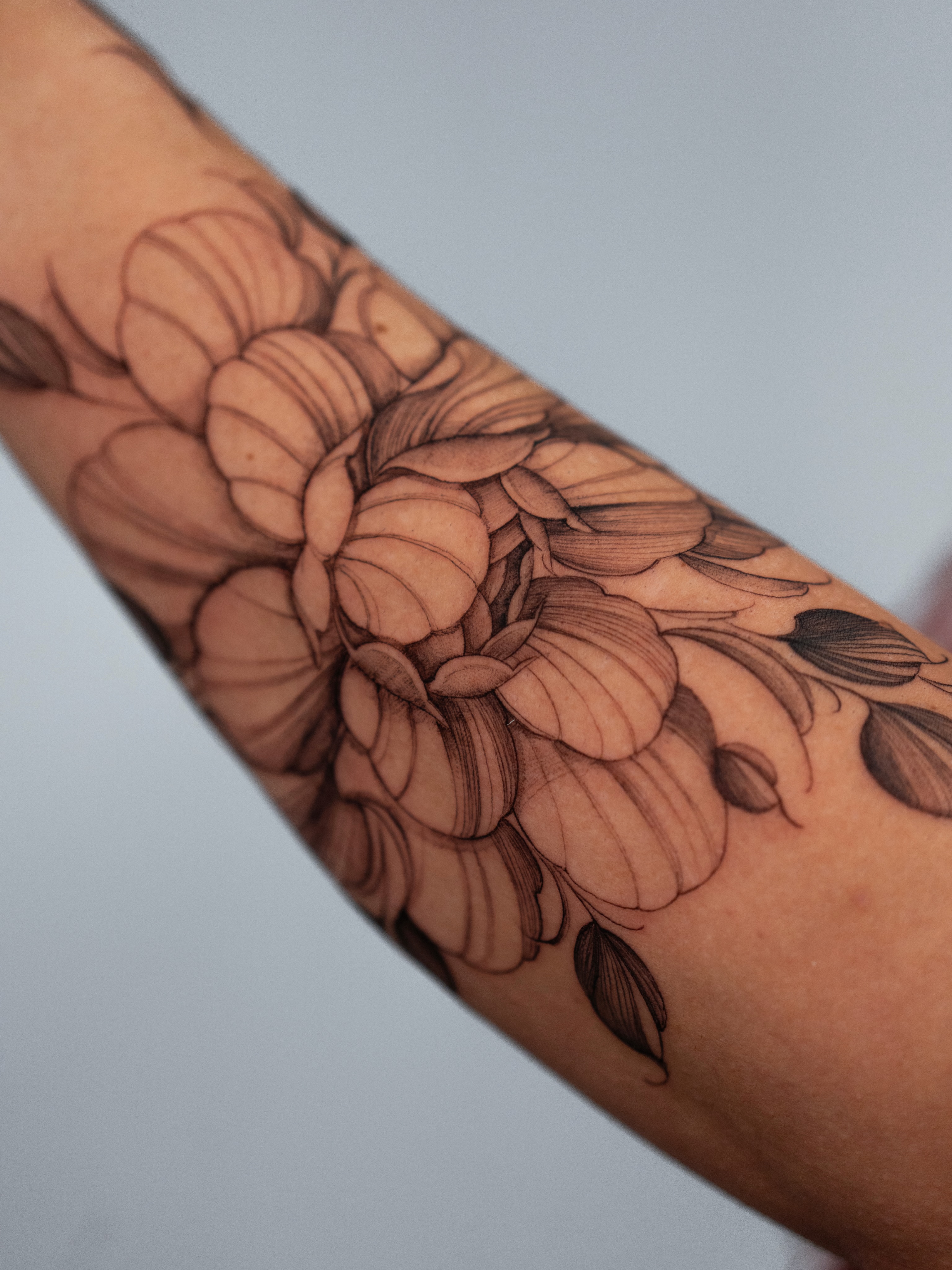 Floral bouquet black and grey tattoo on the forearm by Tattoo fine line NY