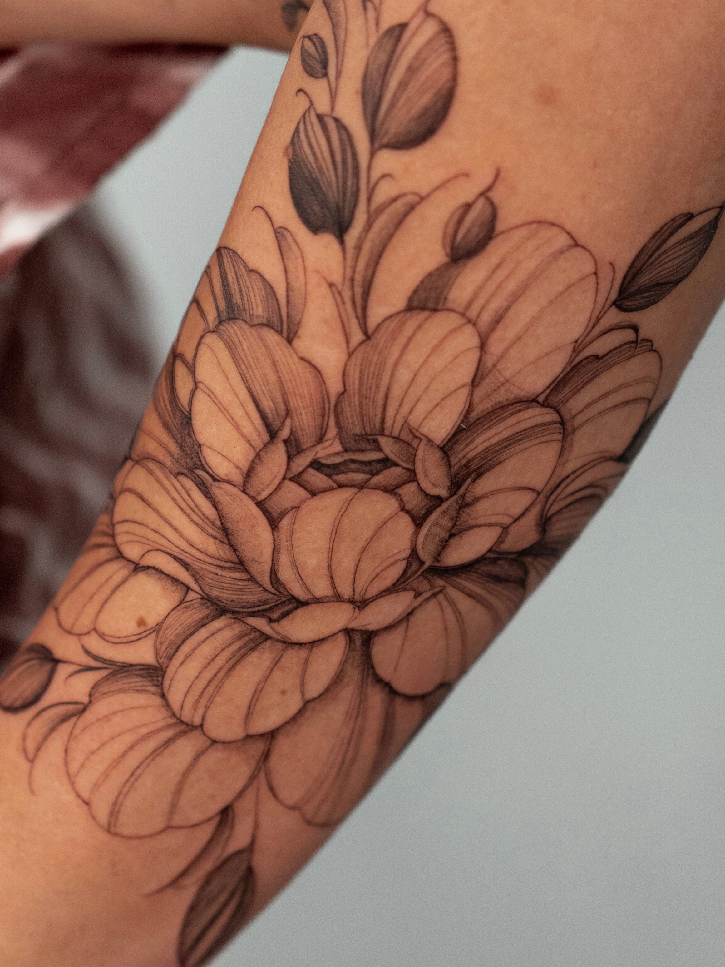Flower bouquet black and grey tattoo on the forearm by Tattoo fine line NY
