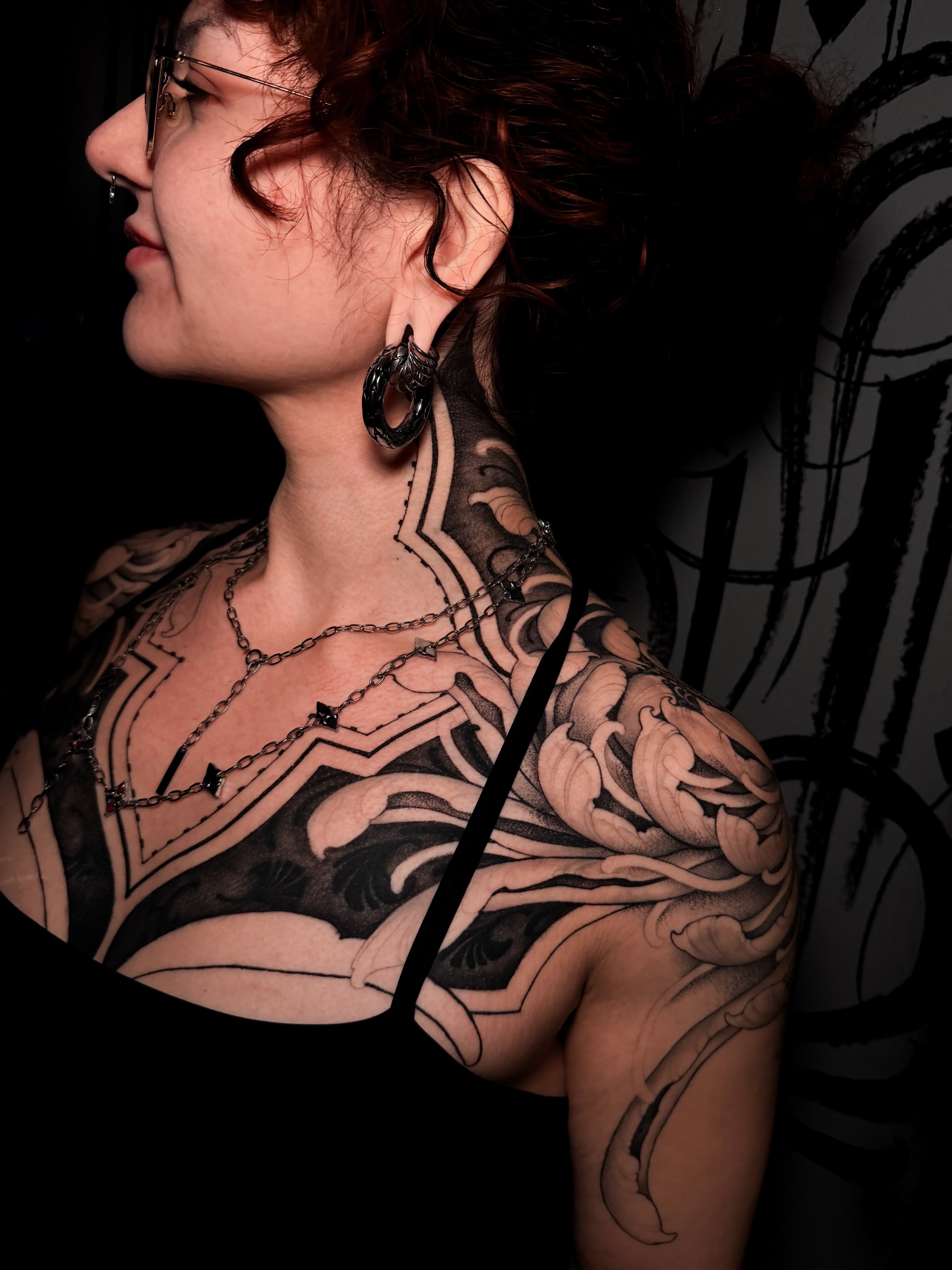 Floral and abstract geometric tattoo on the chest by Carrie