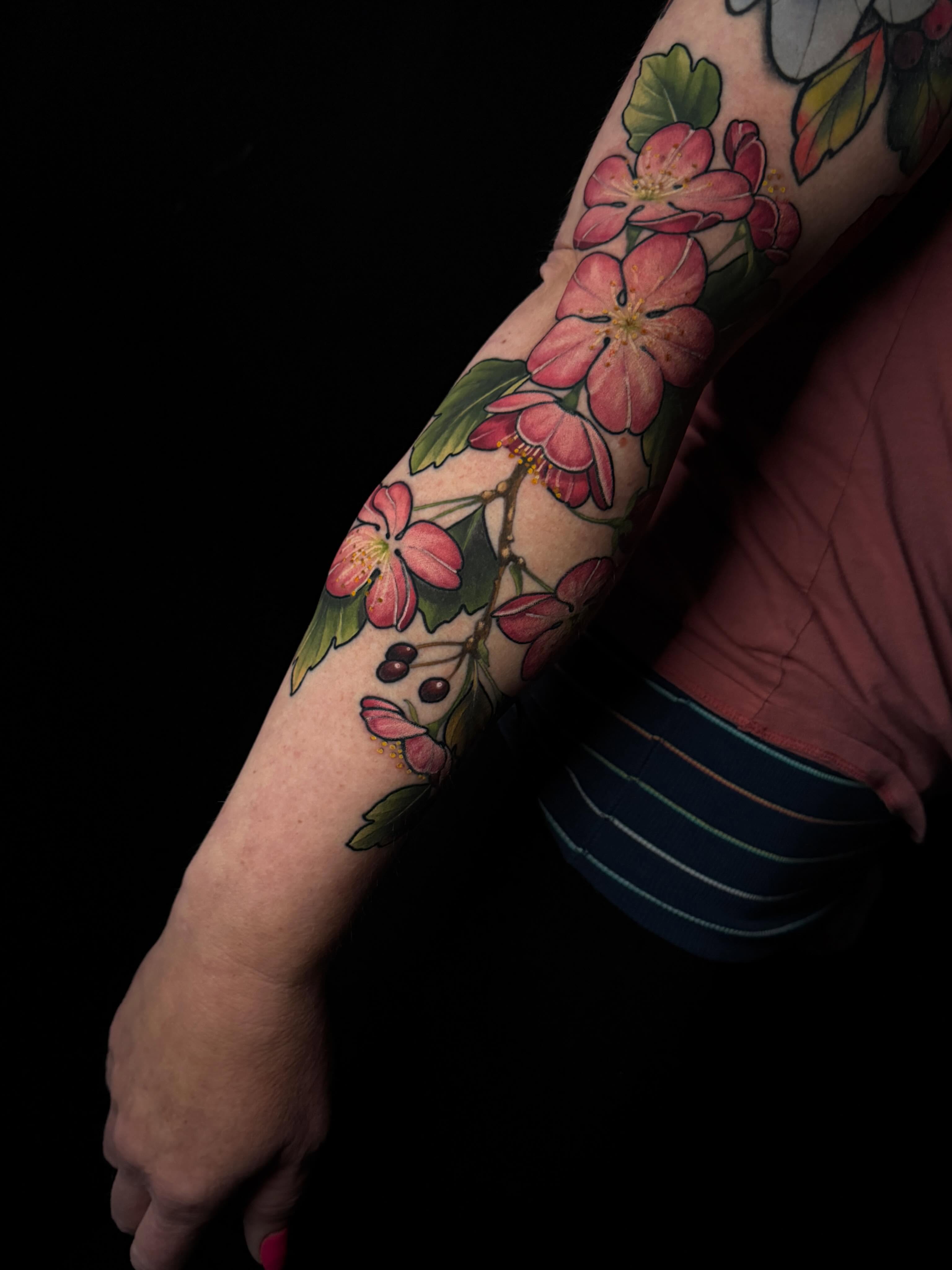 Cherry blossoms realism tattoo on the forearm by Brad Snow