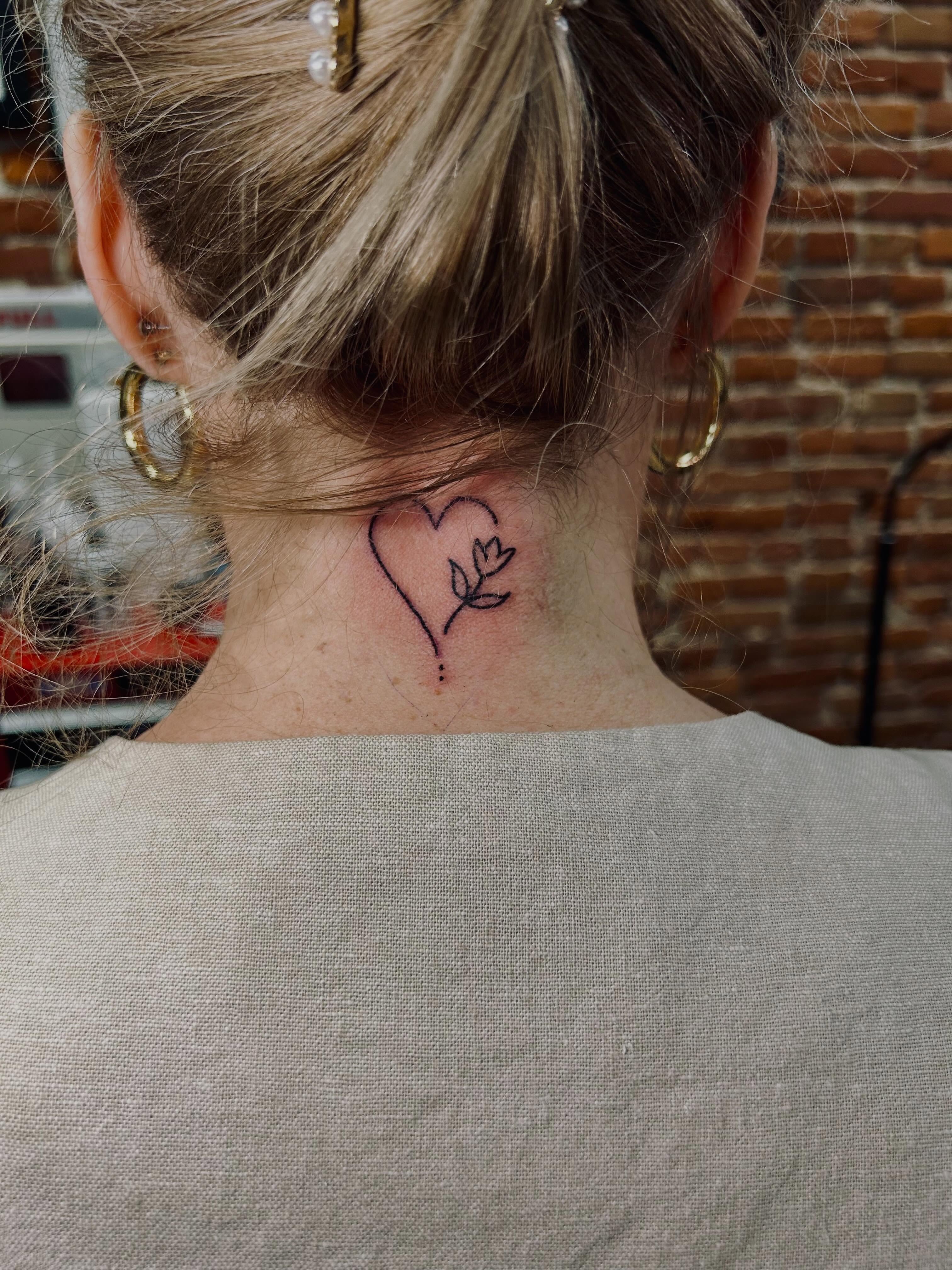 Heart with flower fine line tattoo on the neck by Bjorn Bjornstad, Dubuque, Iowa