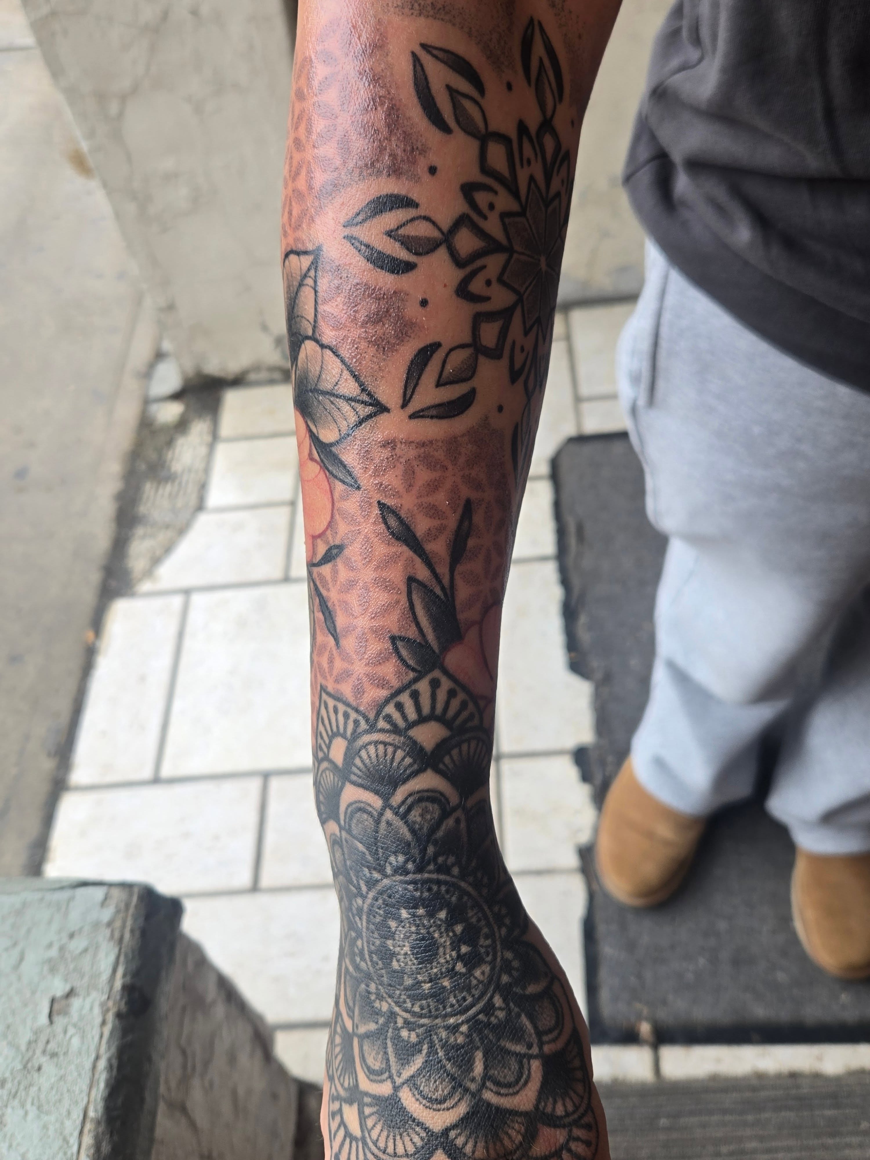 Floral mandala geometric tattoo on the forearm by Angel O'Connor Tattoos