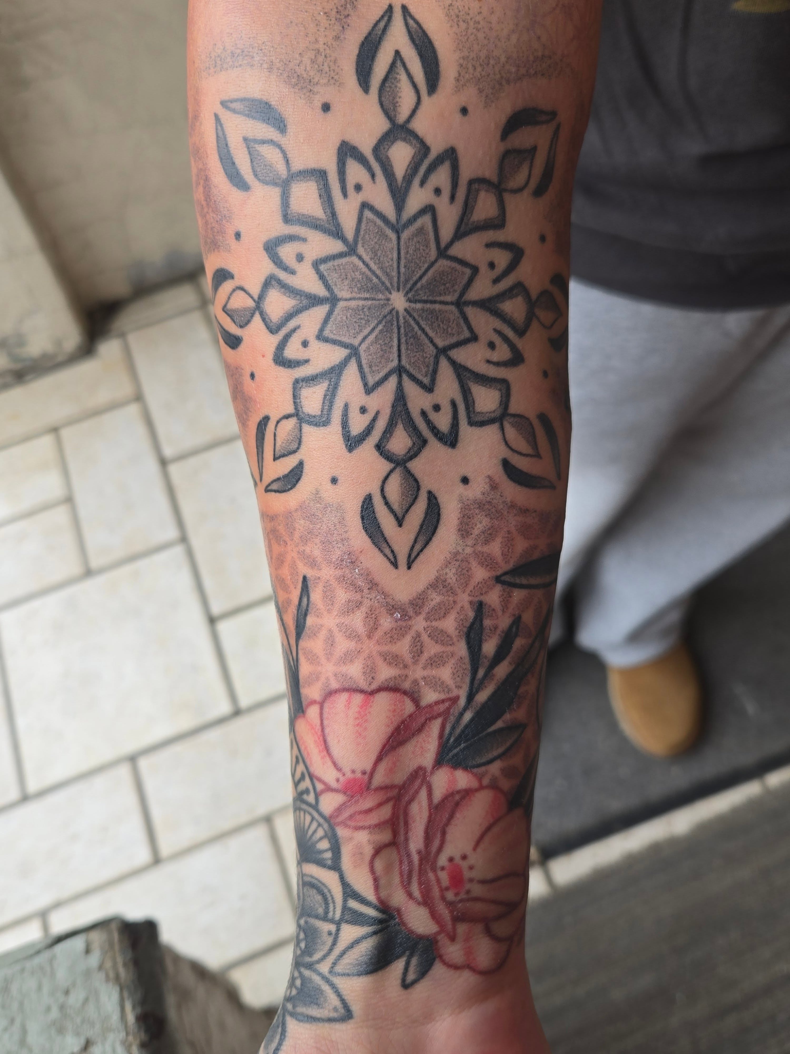 Floral mandala dotwork tattoo on the forearm by Angel O'Connor Tattoos