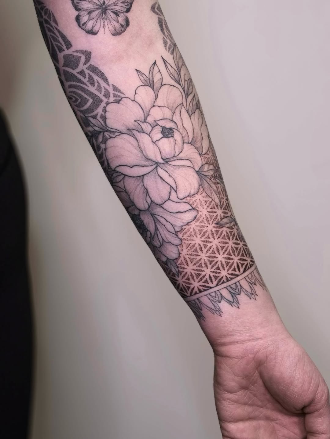 Peony and geometric patterns dotwork tattoo on the forearm by Your tattoo Artist, New York, New York