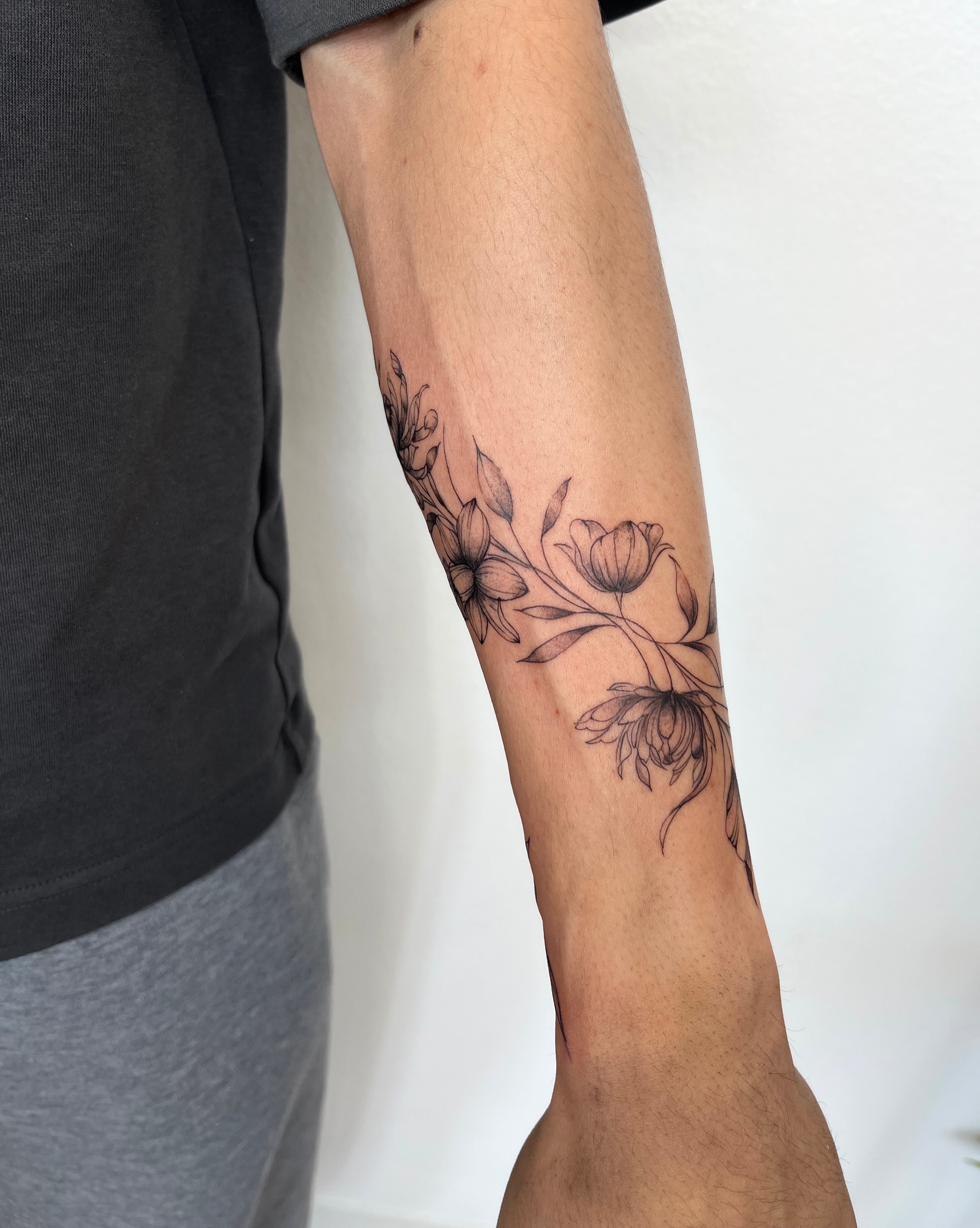 Floral bouquet black and grey tattoo on the forearm by kt