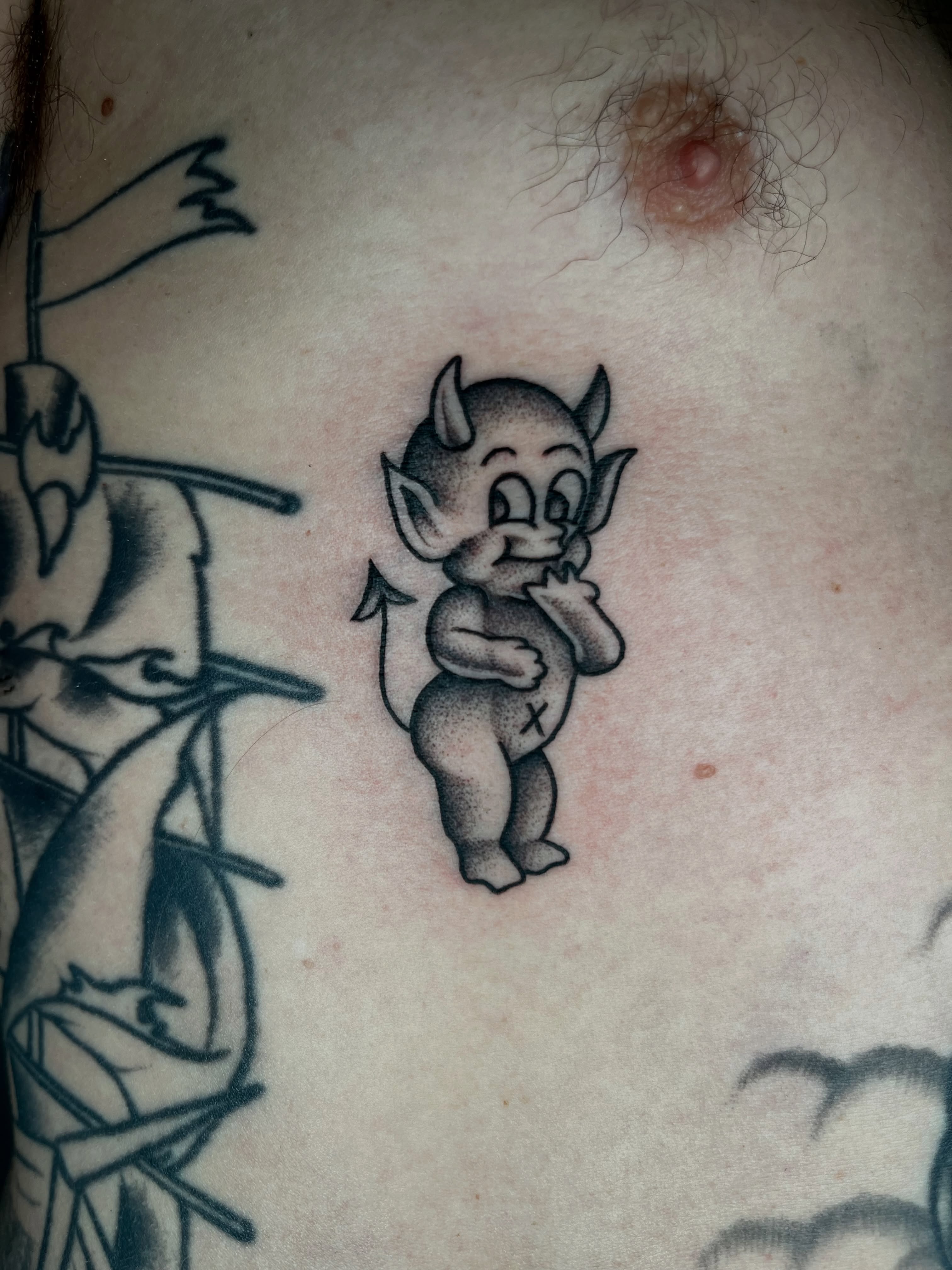 Baby devil dotwork tattoo on the chest by Patrick Elijah