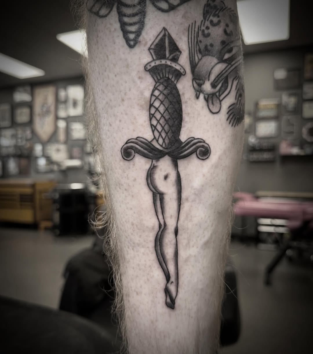 Sword and bird black and grey tattoo on the forearm by ArJay Smith