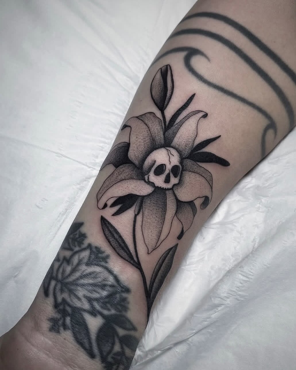 Skull in a lily fine line tattoo on the forearm by 🕸 ᴠɪᴠɪᴀɴ ʟᴏʀᴇ 🕸, Nashville, Tennessee