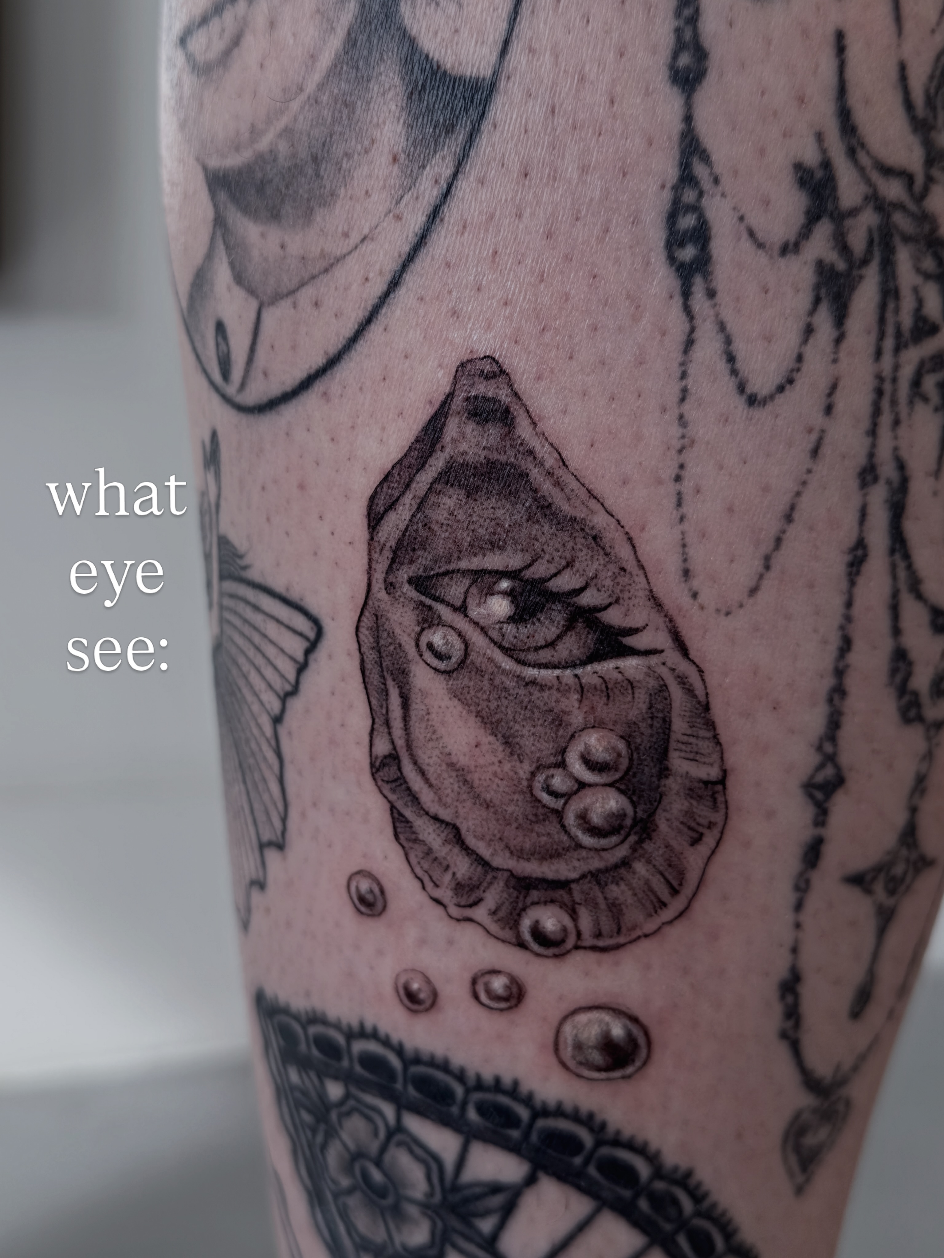 Eye in oyster shell black and grey tattoo on the forearm by Sadie Spades Philly Tattoos