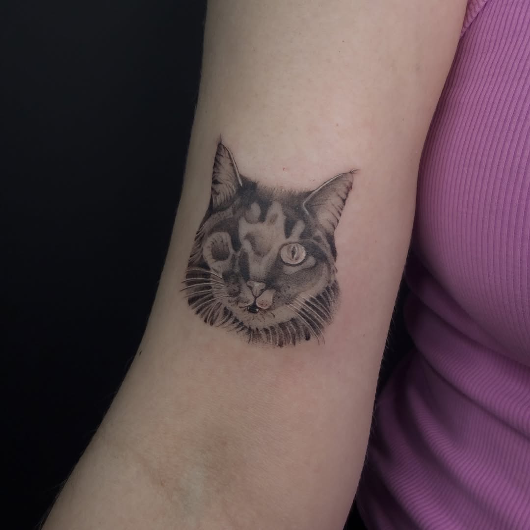 Cat portrait realism tattoo on the forearm by Vu Nguyen